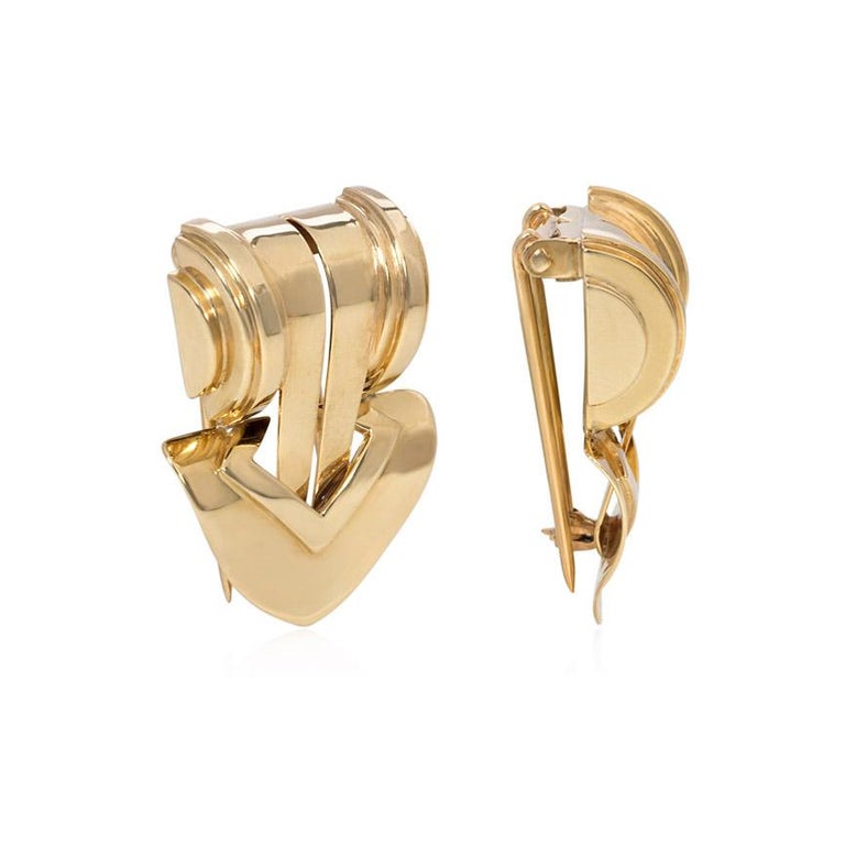 A pair of Retro gold clip brooches of scrolled and tapered geometric design with arrow-shaped ends, in 14k. Tiffany & Co.

Stylish and streamlined in design, these clips would look fabulous on lapels, necklines, waistbands, hats - the options are