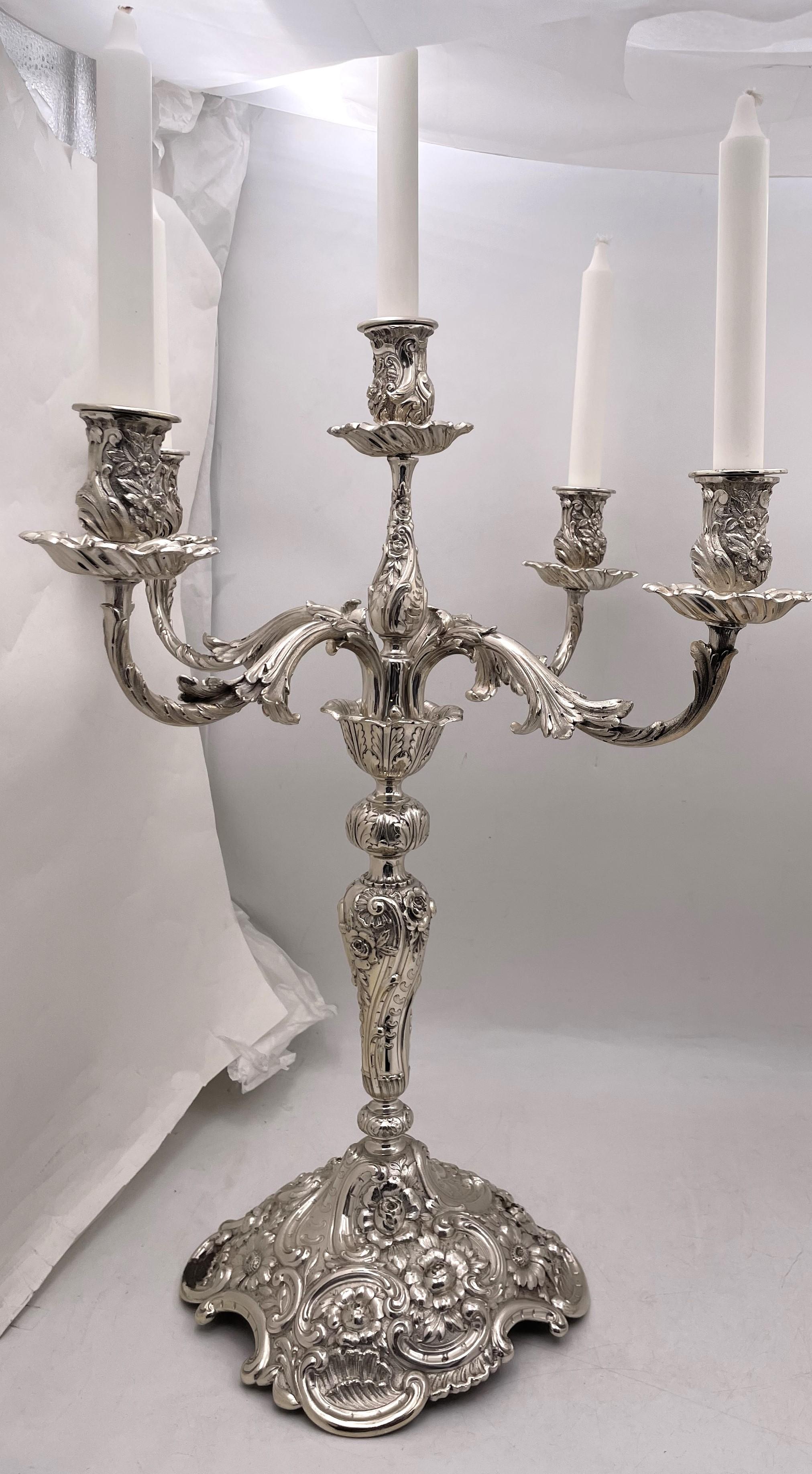 Pair of Tiffany & Co. sterling silver 5-light monumental candelabra in the tasteful, hand-chased repousse motif, finely executed with a spread of 5 arms. From circa 1907 and in crisp condition, they measure 24'' in height by 19'' from arm to arm.