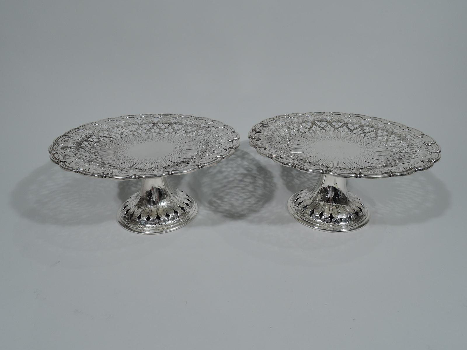 Pair of Edwardian Art Nouveau sterling silver compotes. Made by Tiffany & Co. in New York, circa 1907. Each: Round and shallow bowl on upward tapering shaft flowing into raised foot. Well center solid with engraved leaves and tendrils surrounded by
