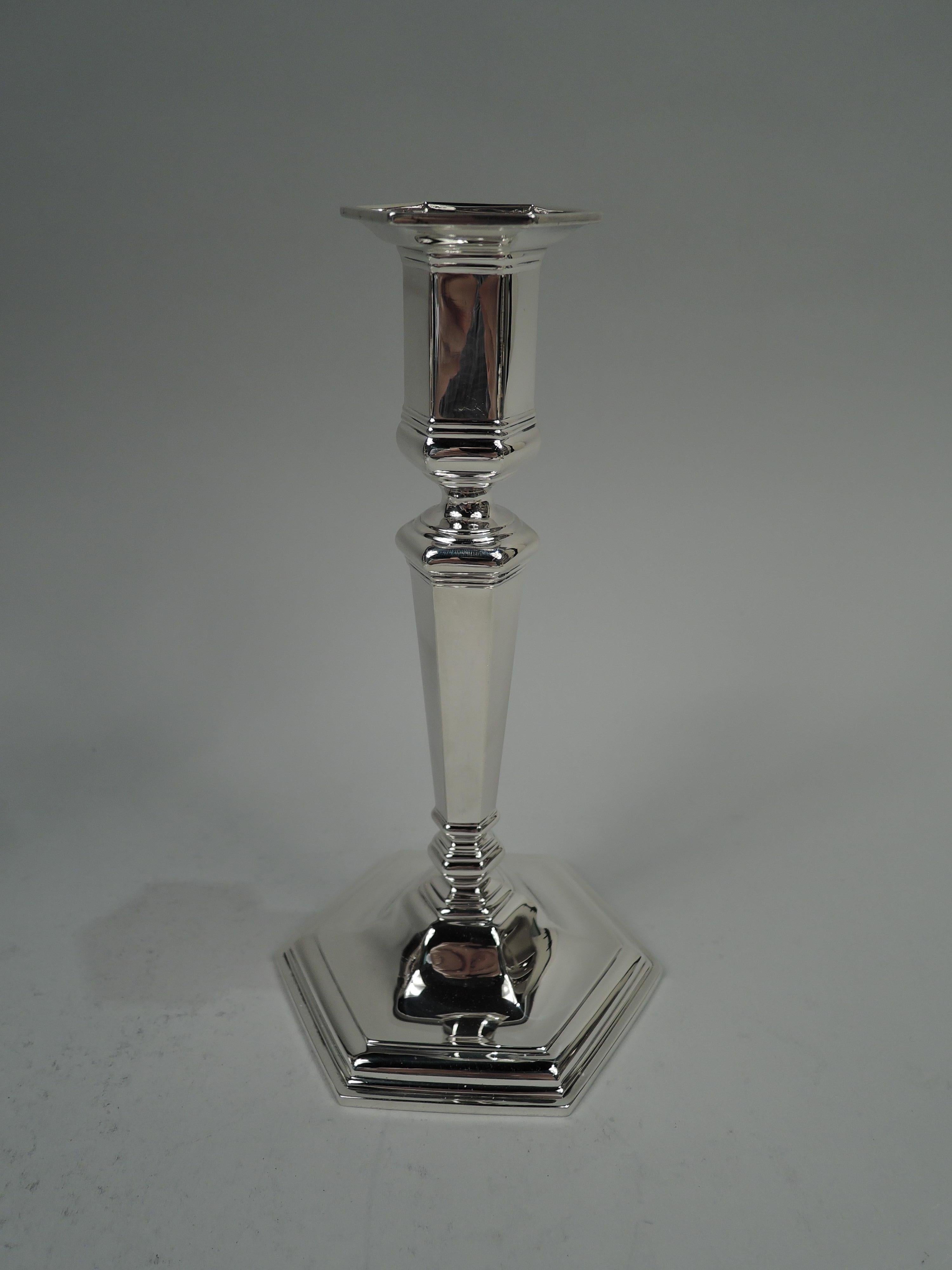 Pair of Edwardian Georgian sterling silver candlesticks. Made by Tiffany & Co. in New York, ca 1915. Each: Tapering shaft with base knop on stepped and raised foot. Socket has straight sides bellied bottom. Faceted. Fully marked including maker’s