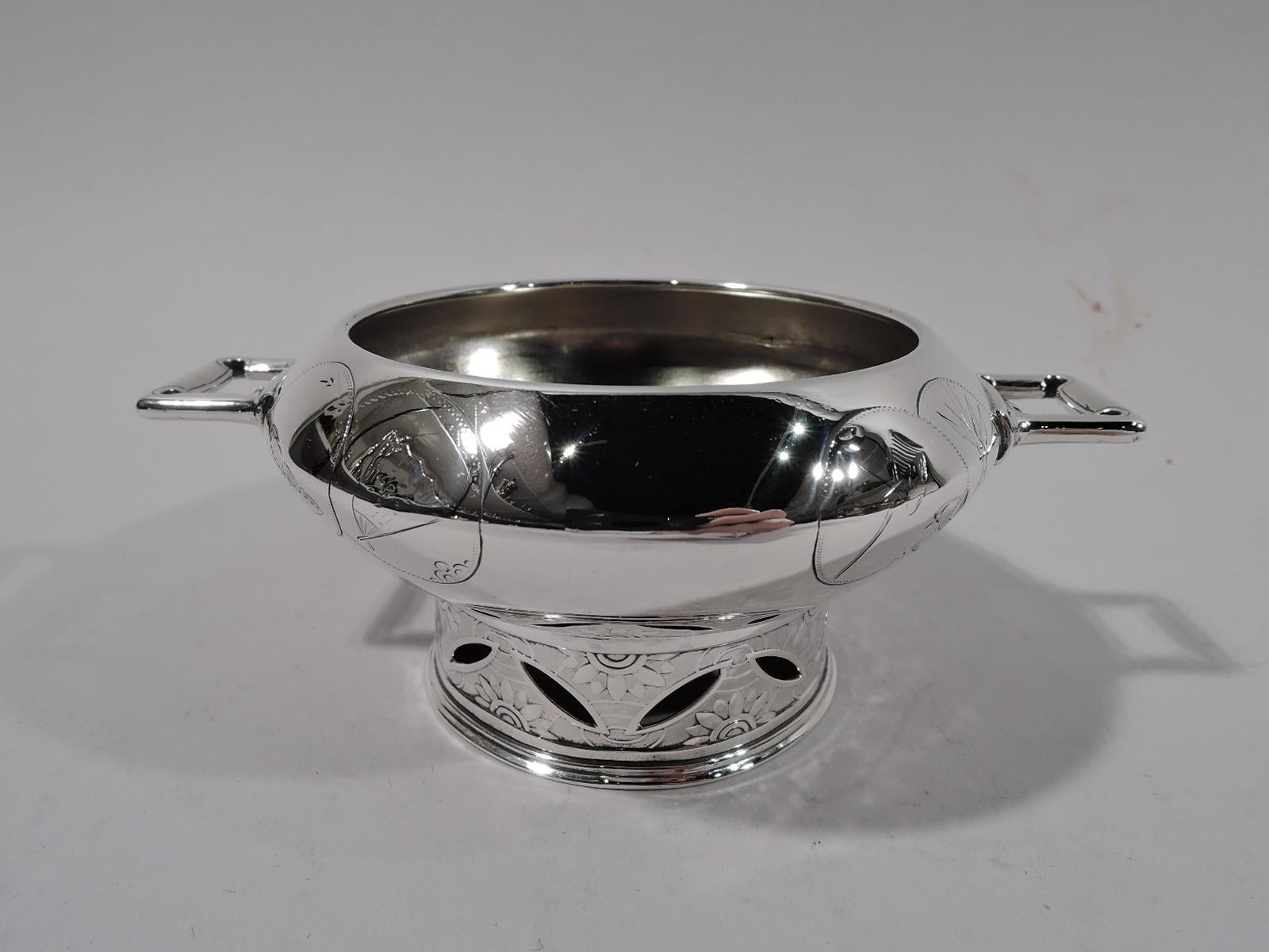 Pair of Japonesque sterling silver open salts. Made by John C. Moore for Tiffany & Co. in New York. Round with open rectangular bracket handles and straight foot. Engraved overlapping seals decorated with modish motifs, including fan, bug, vase, and