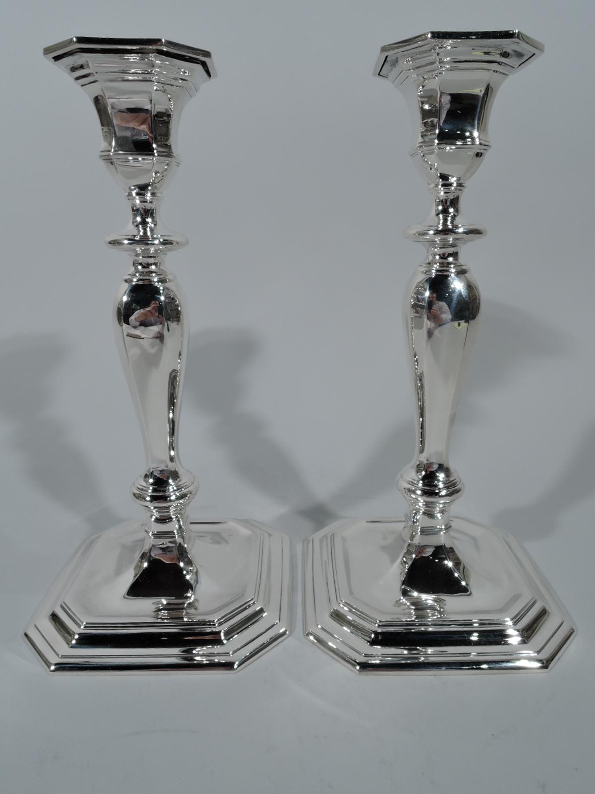 Pair of Georgian sterling silver candlesticks. Made by Tiffany & Co. in New York, circa 1913. Each: Faceted and knopped baluster shaft on stepped and chamfered square base. Faceted urn socket with flat and chamfered detachable bobeches. Olden-days