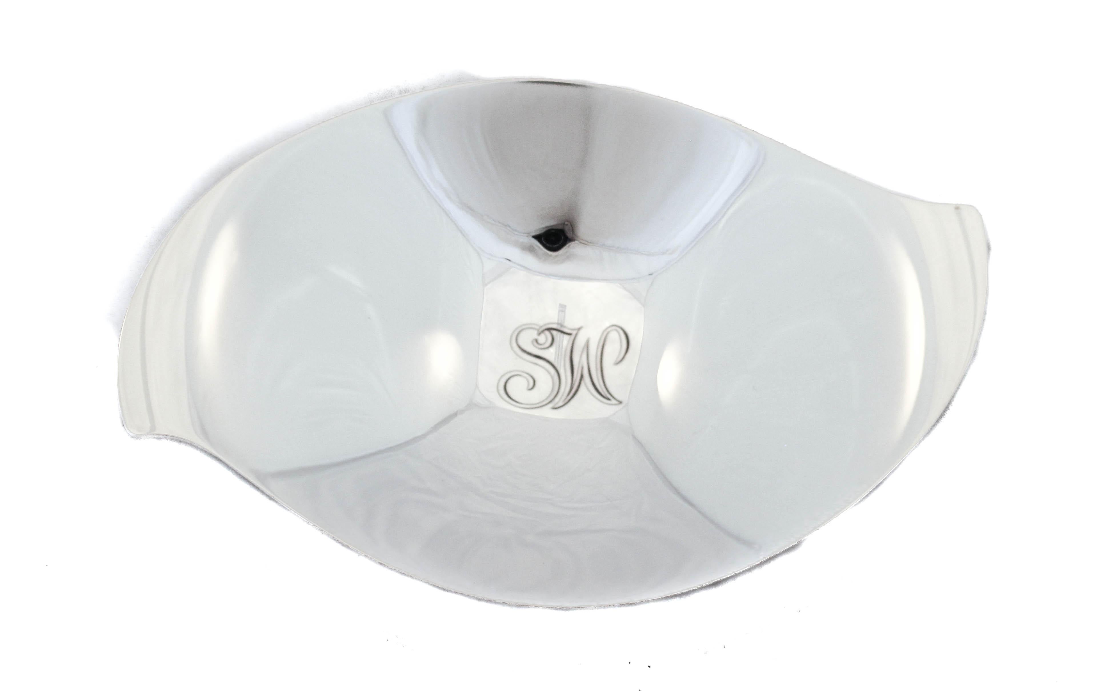 We are happy to offer you this pair of sterling silver dishes by the world renowned Tiffany & Company. With their distinctive Mid-Century style and shape they are sure to look beautiful in your home. They have a swirl shape and stand on four balls.