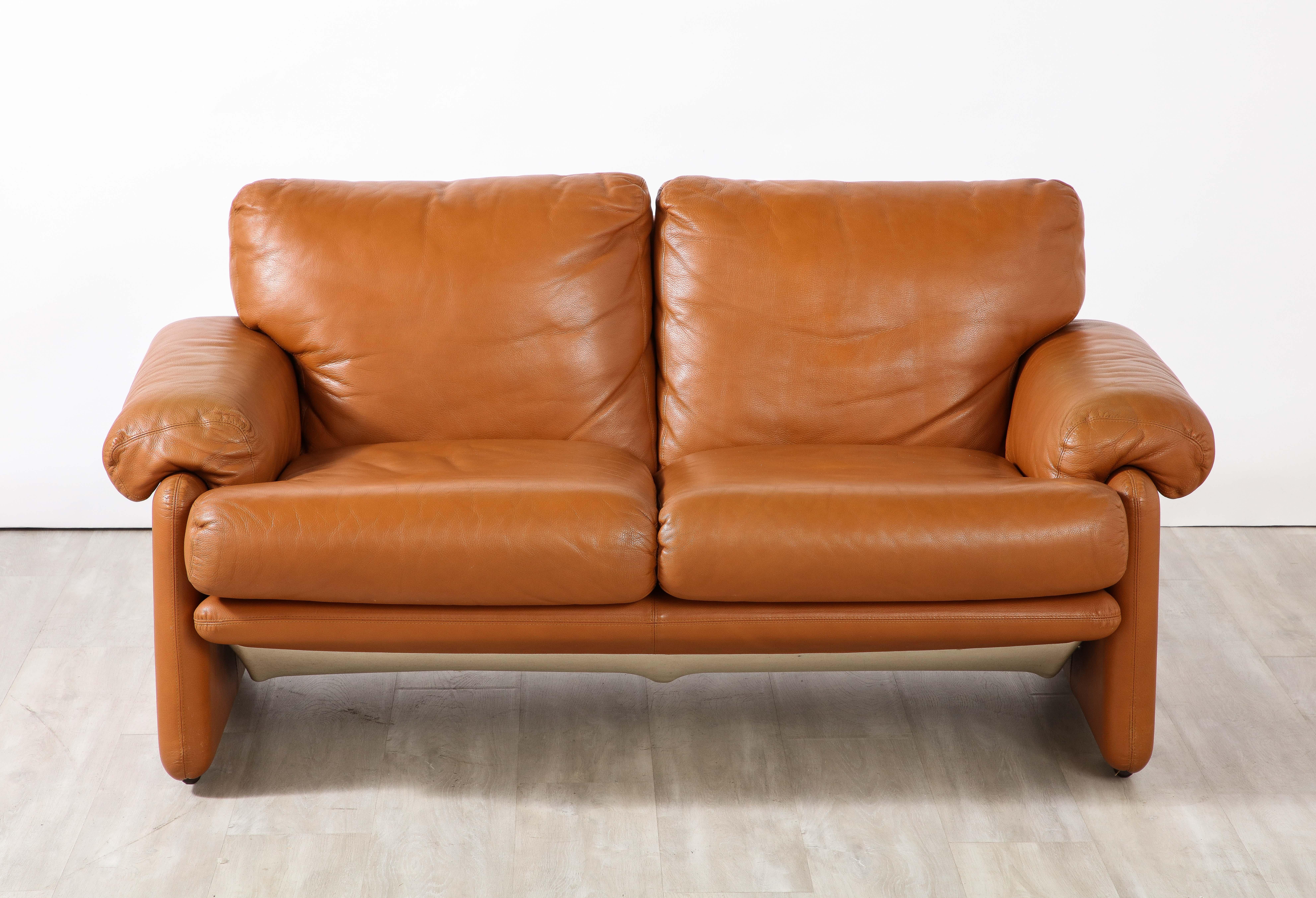 A pair of 'Coronado' two seat sofas in beautiful cognac leather, designed by Tobia Scarpa and manufactured by the Italian firm, B&B Italia, circa 1975. 

The seating are made with a then revolutionary kind of molded polyurethane foam for excellent