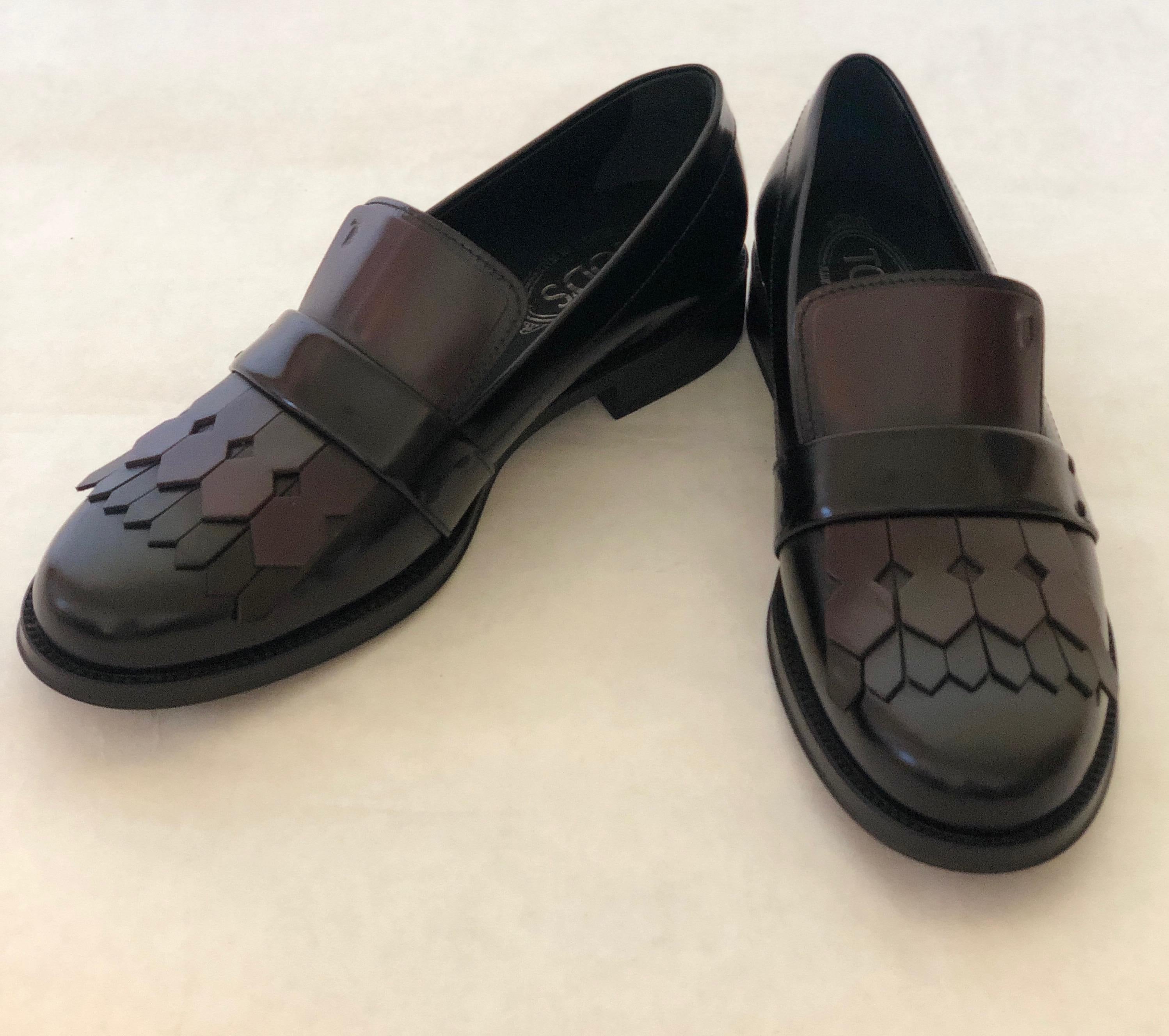 Make:  Tod's
Place of Manufacture:  Italy
Size:  39.5 EU
Materials:  Leather uppers and rubber sole (Tod's signature no skid sole)
Color:  Cordovan (burgundy) and black
Style:  Cordovan and black leather kiltie tassel flap loafers with Tod's