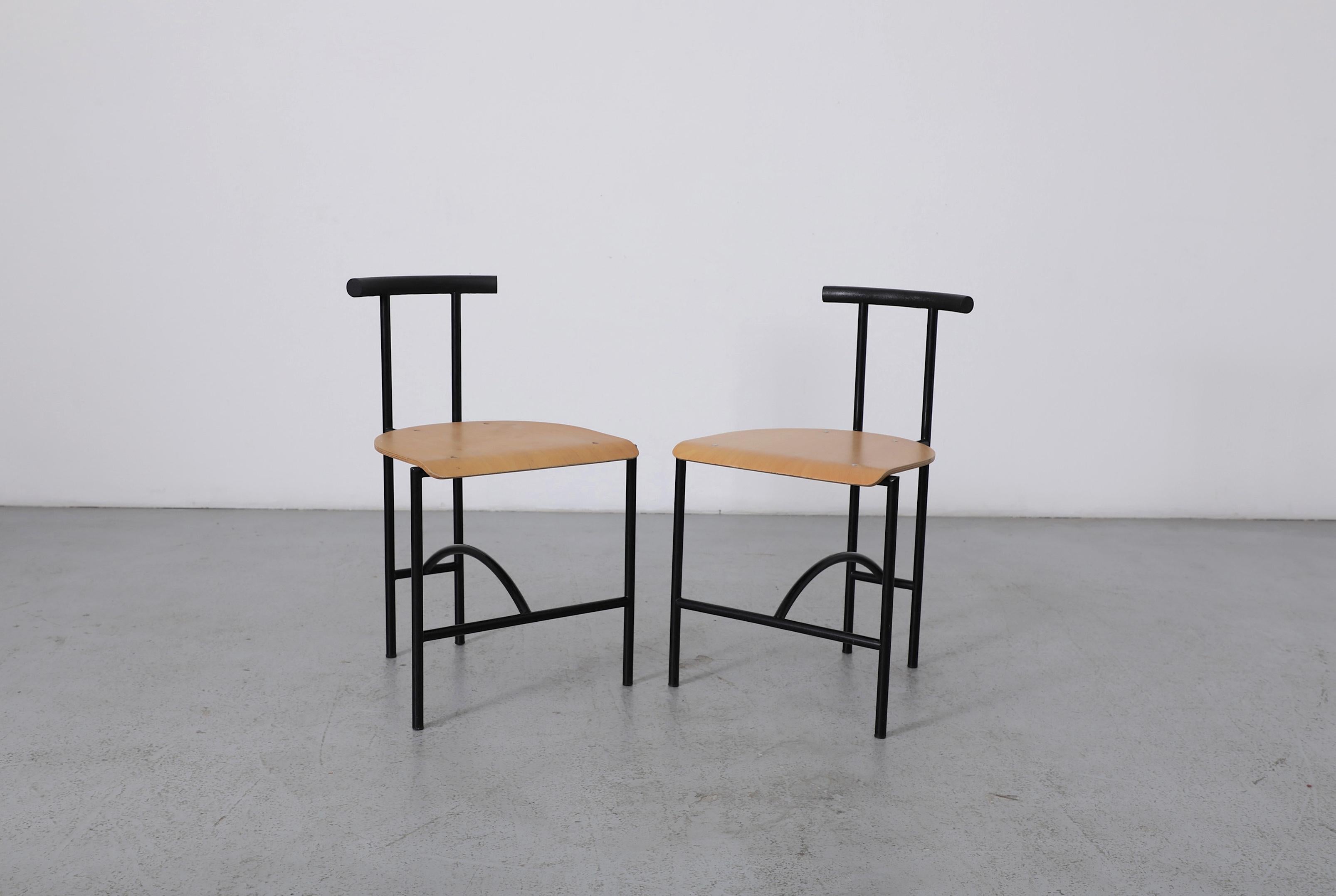 Pair of Postmodern 'Tokyo' dining chairs by Rodney Kinsman for Bieffeplast, 1980's. Black powder coated tubular metal frames with a contrasting natural wood seat and finished with a curved soft rubber back rest. These popular dining chairs are a