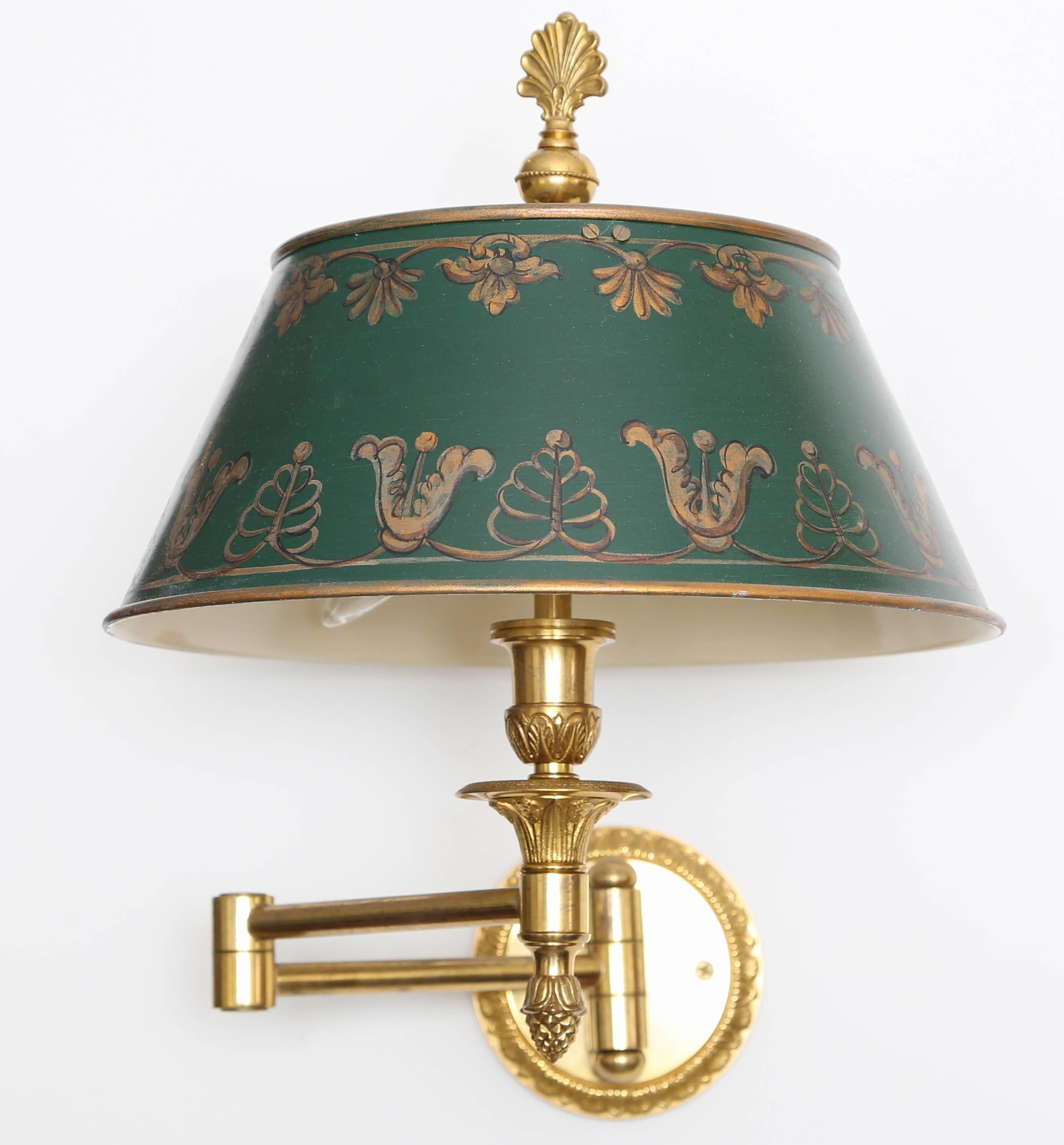 Solid brass dual swing arm sconces with hand-painted hunter green and gold tole shades.