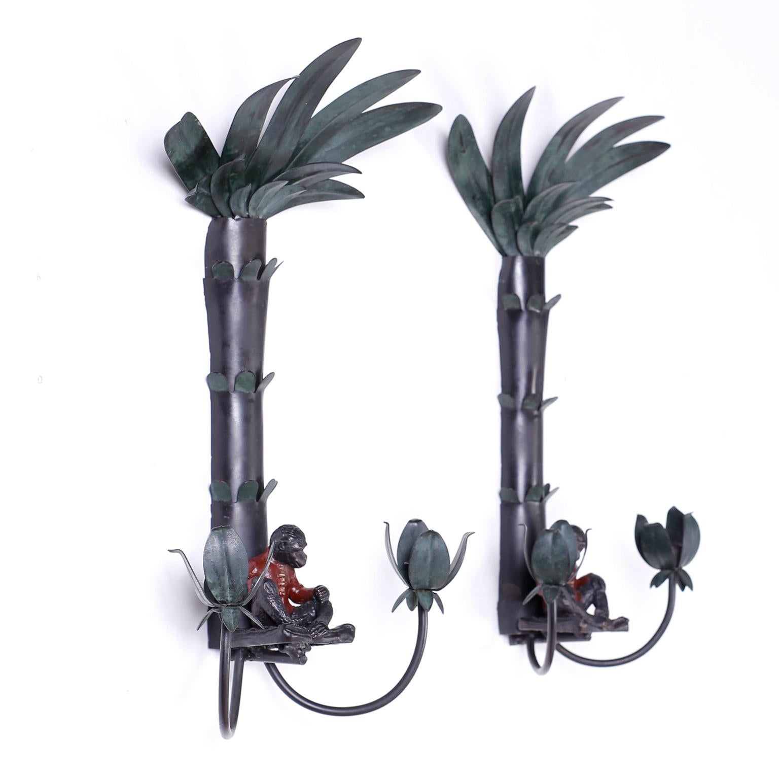 Pair of tole sconces with stylized palm trees, two candle holsters and presided over by well dressed monkeys.