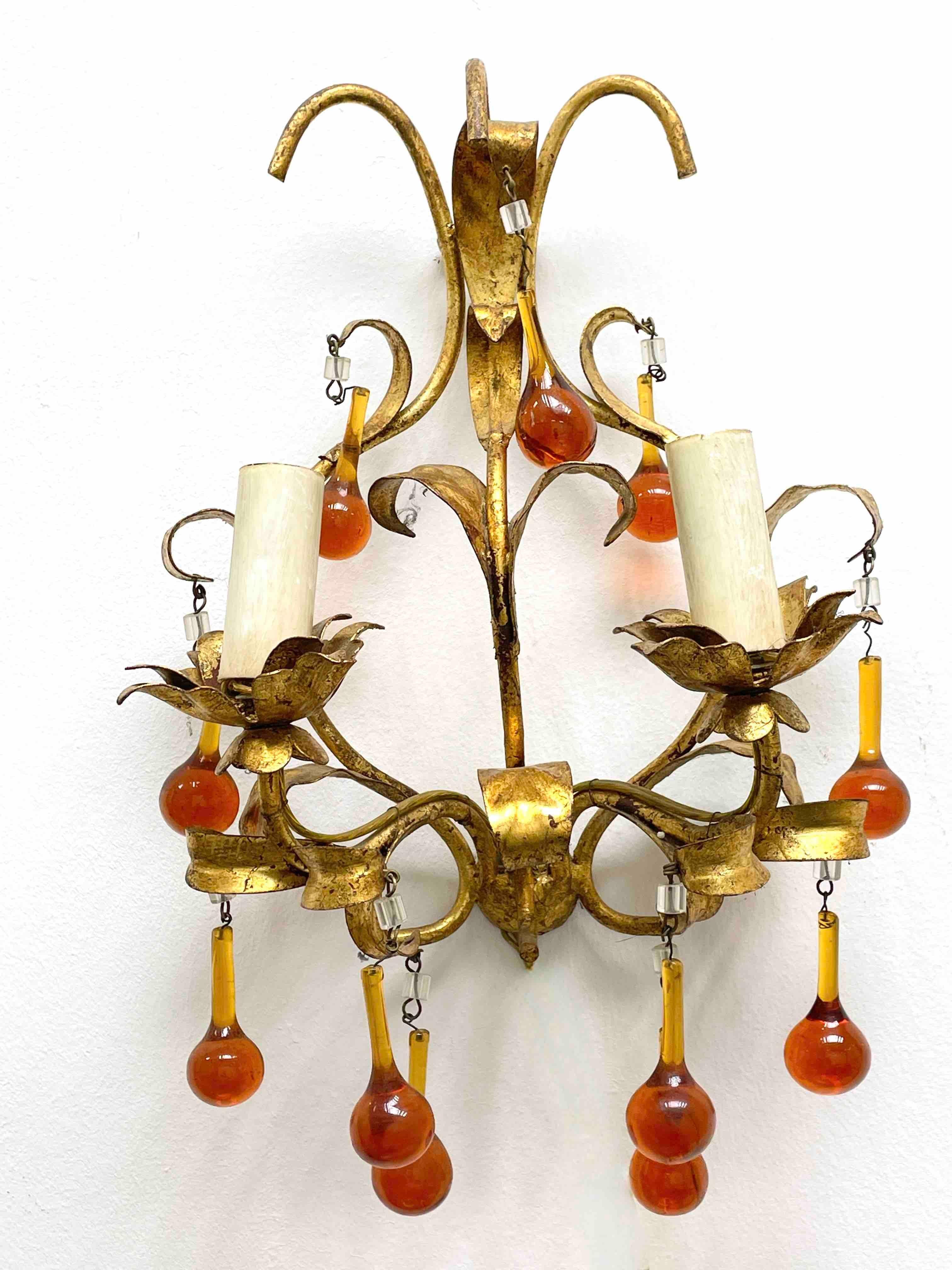 A pair Hollywood Regency midcentury gilt tole leaf sconces with glass drops, each fixture requires two European E14 candelabra bulbs, up to 40 watts each socket. The wall lights have a beautiful patina and gives each room a eclectic statement.