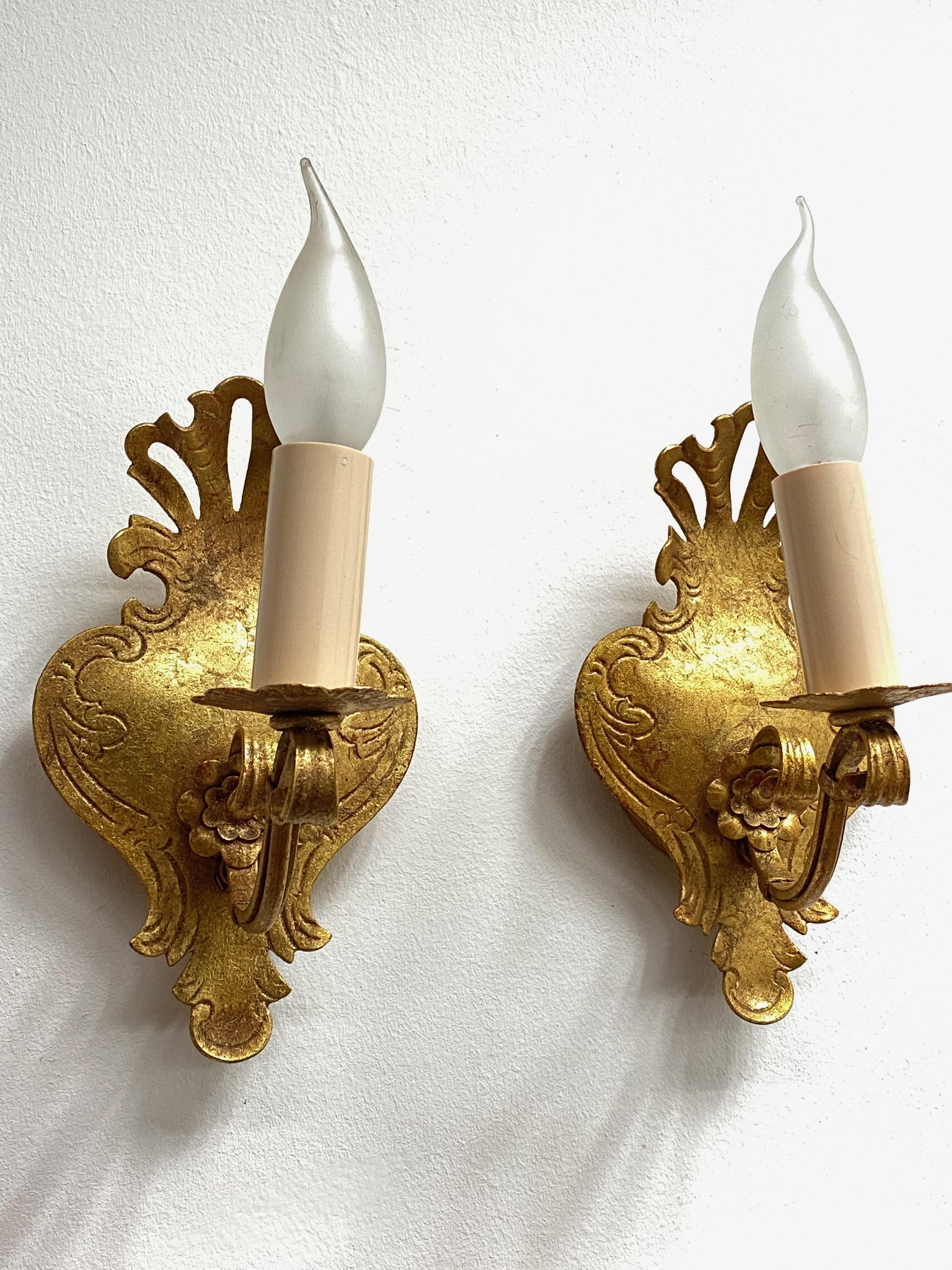 A pair Hollywood Regency midcentury gilt tole sconces, each fixture requires one European E14 candelabra bulb, up to 60 watts. The wall lights have a beautiful patina and give each room a eclectic statement. Made by Reindl Leuchten, Germany. Bulbs