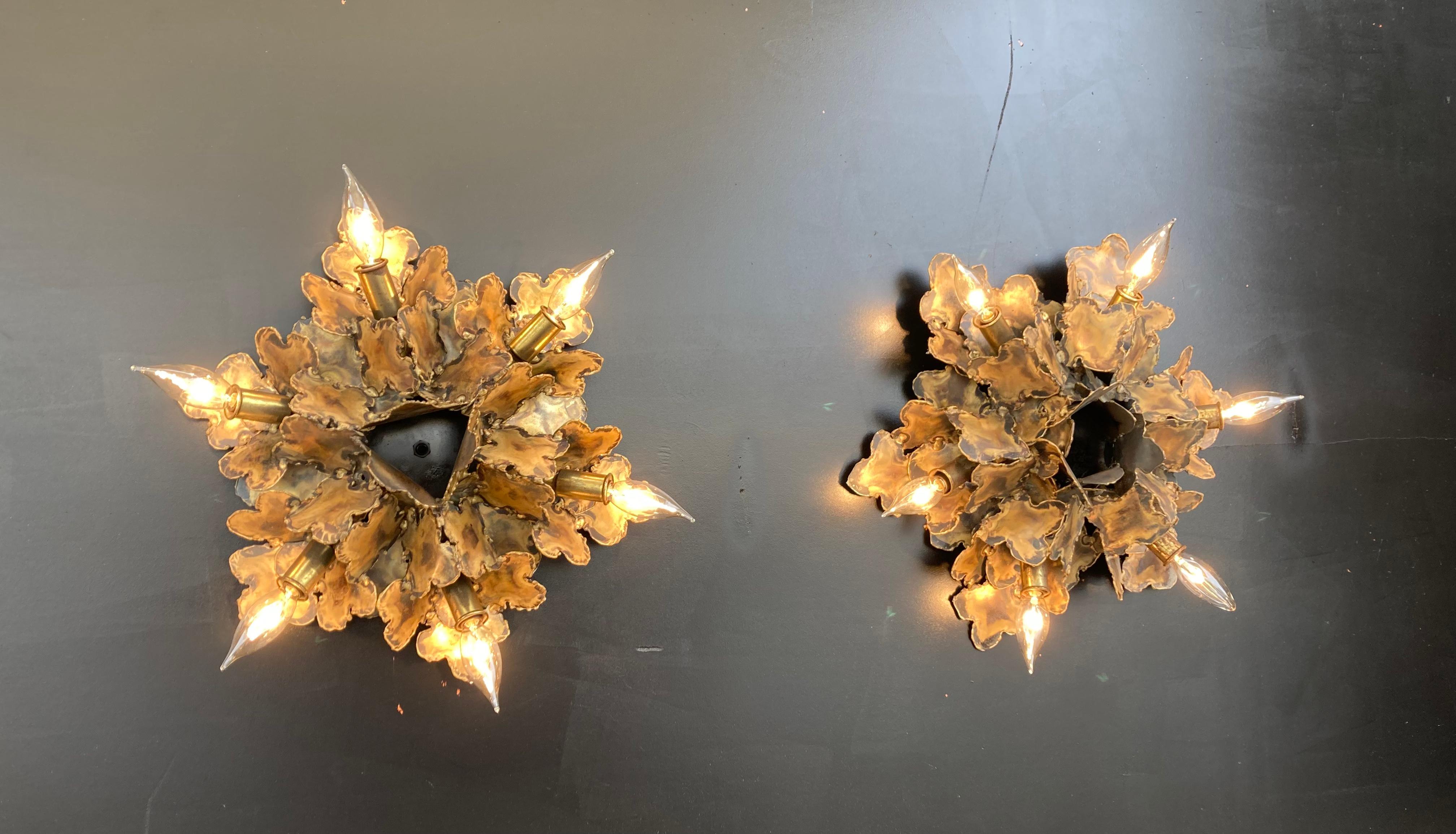 Torch cut and patinated brass sconces by Tom Greene for Feldman.
Each Sconce has six sockets.