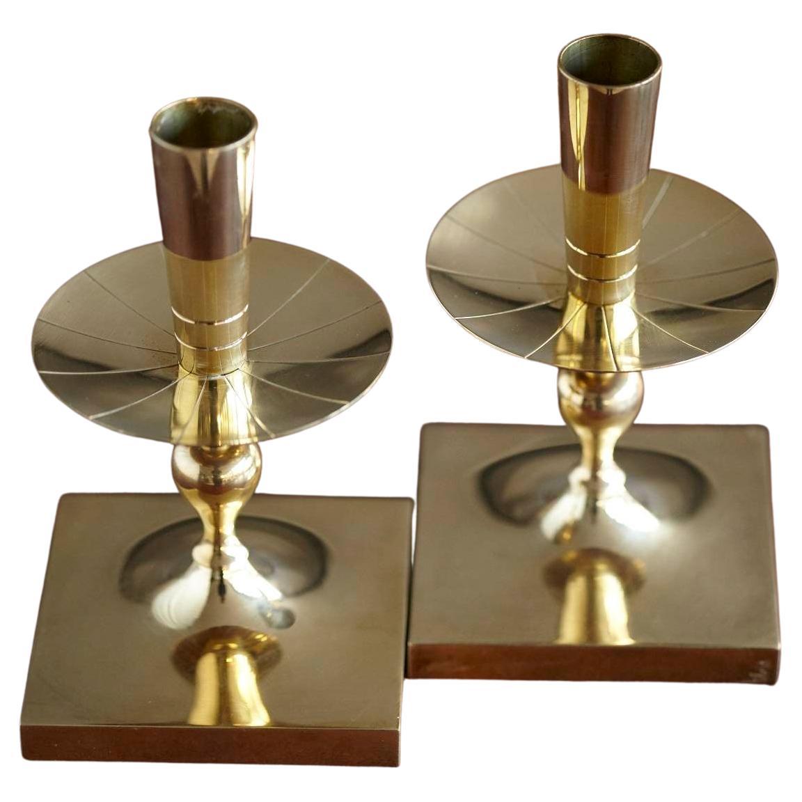 Elegant pair of Tommi Parzinger solid brass candleholders made by Dorlyn Silversmiths New York, manufacturers hallmark engraved on the bottom.
