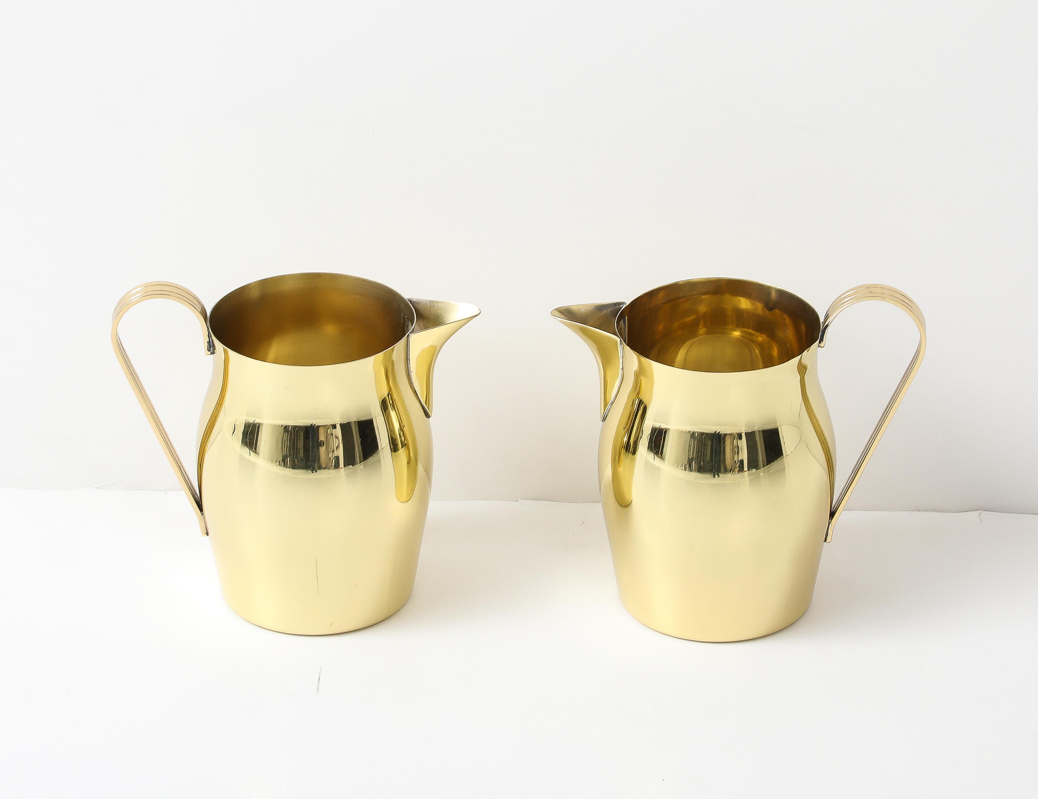 Rare pair of solid brass pitchers designed by Tommi Parzinger, c 1960s. 
Professionally polished and lacquered.