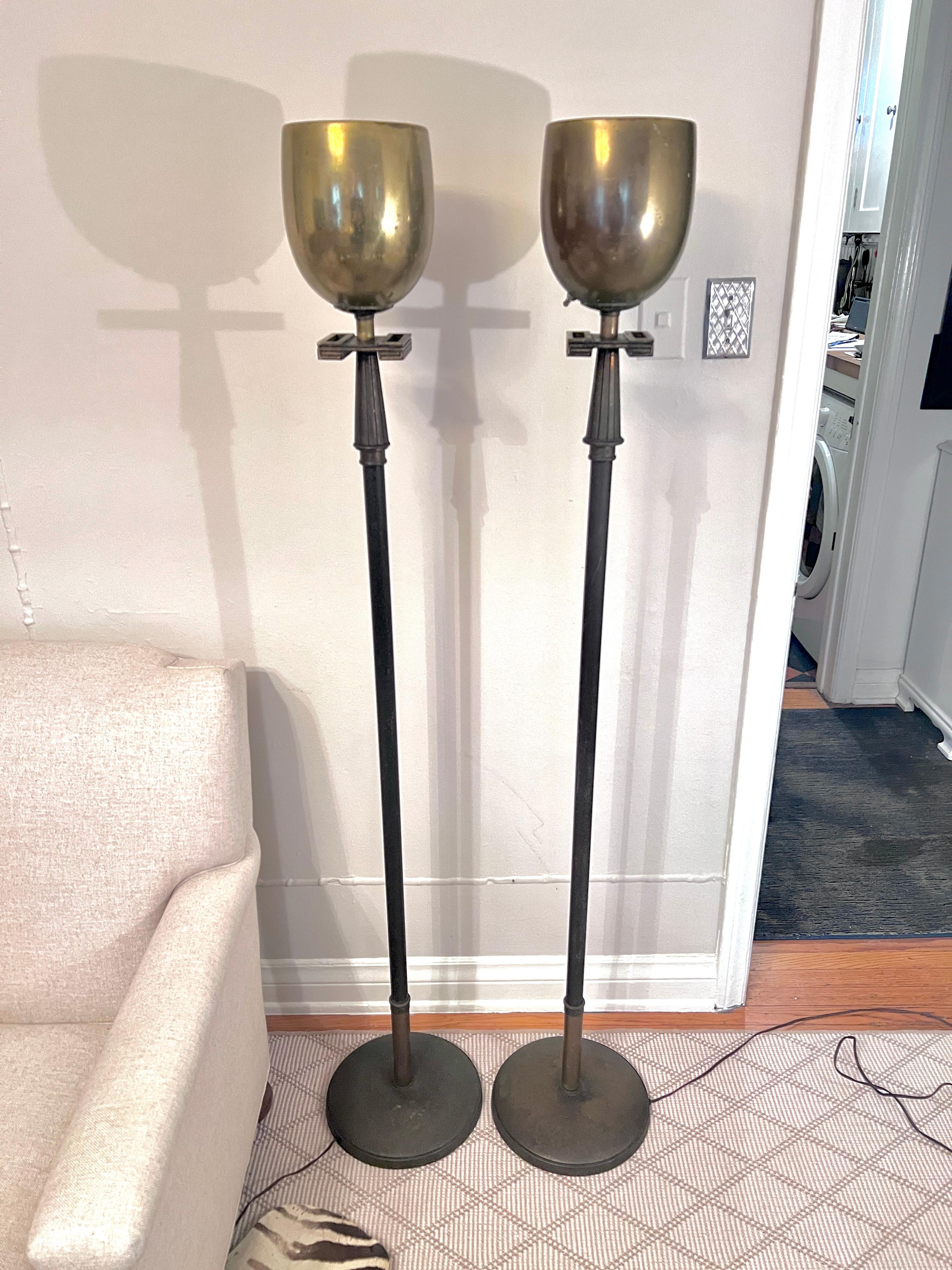 A pair of Mid Century Brass Torchieres by Iconic Designer, Tommi Parzinger.  The pair are great design and look great flanking a doorway, or spaced about in a room.  Perfect for most any room, from Master Bedroom - Living room.

The lamps have a