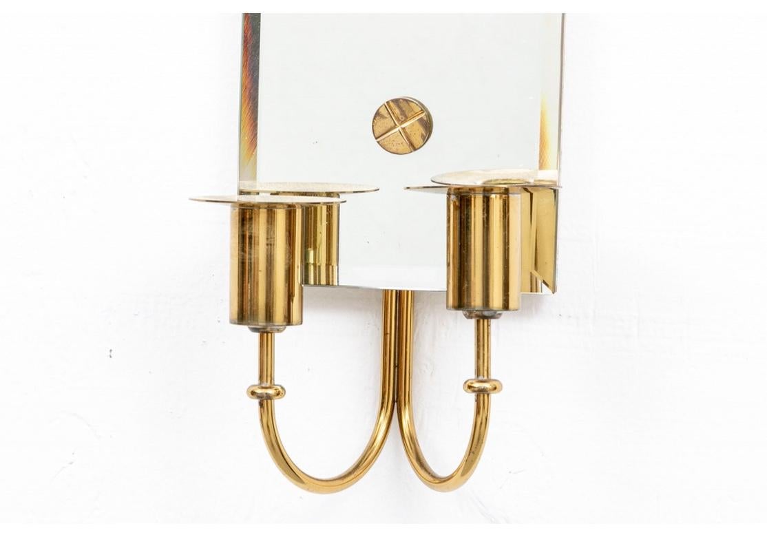 Very fine pair of elegant mirrored candle sconces with brass candle holders and accents by Tommi Parzinger for Parzinger Originals, American, 1950's. Dimensions W 6 in; H 29.5 in; D 4 in;
Condition: Very good with acceptable age borne wear (see