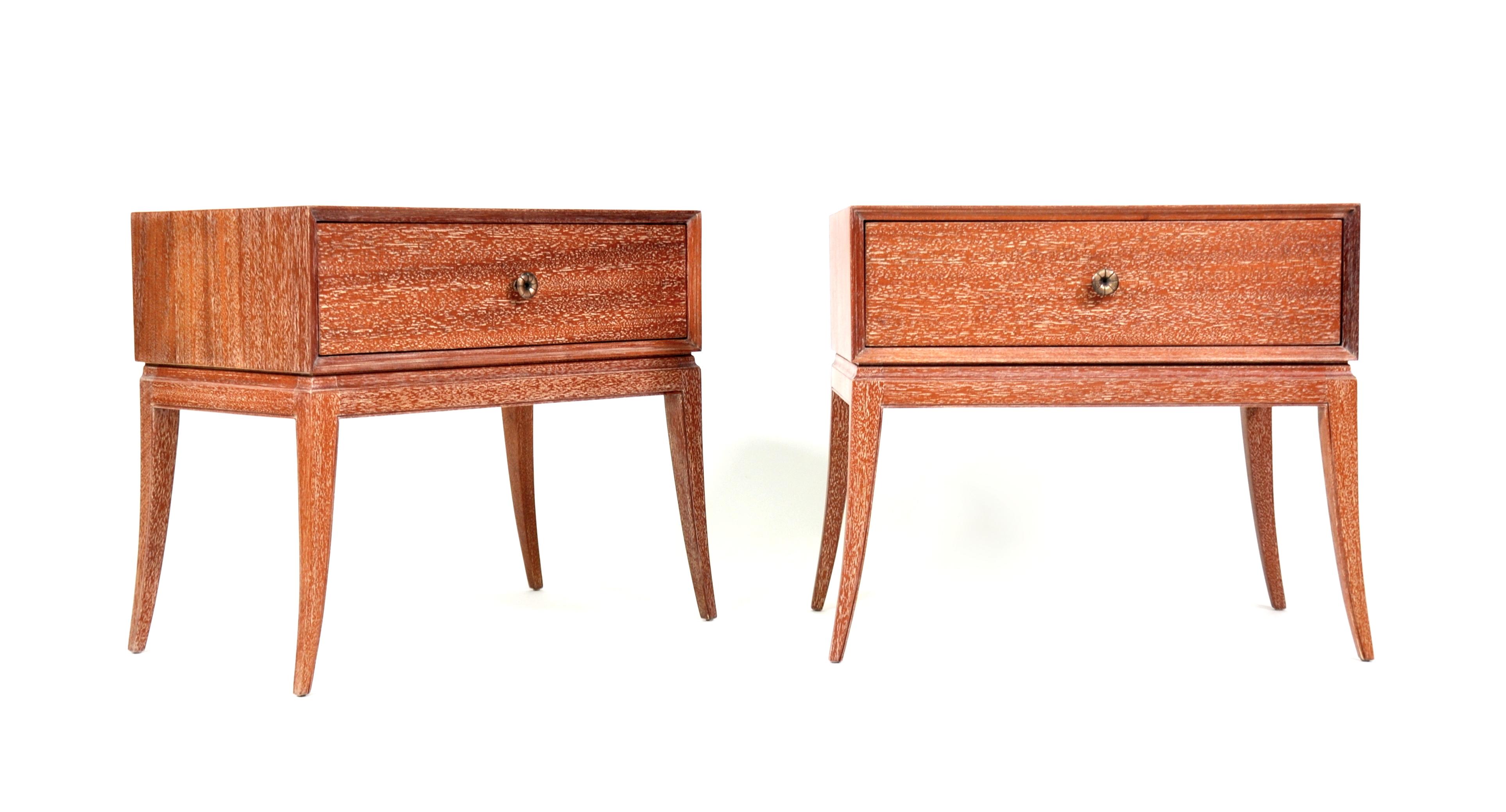 A gorgeous pair of Mid-Century Modern cerused mahogany and patinated brass bedside or end tables designed by Tommi Parzinger, and manufactured by Charak Modern. The nightstands are fitted with a drawer, the whole raised on elegant sabre legs. Each