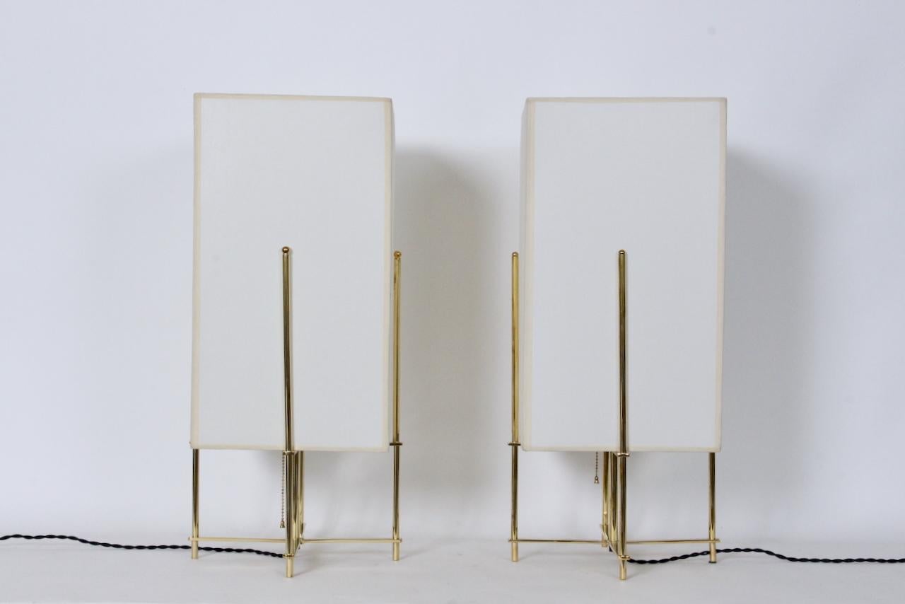 Pair Tommi Parzinger style bright brass table lamps with Parchment shades. Featuring a open, braced, balanced professionally re-polished Brass frameworks (11.5 Wx 11.5D x 16.5H), rectangular custom Off White Parchment lamp shades (10W x 10D x 18H),