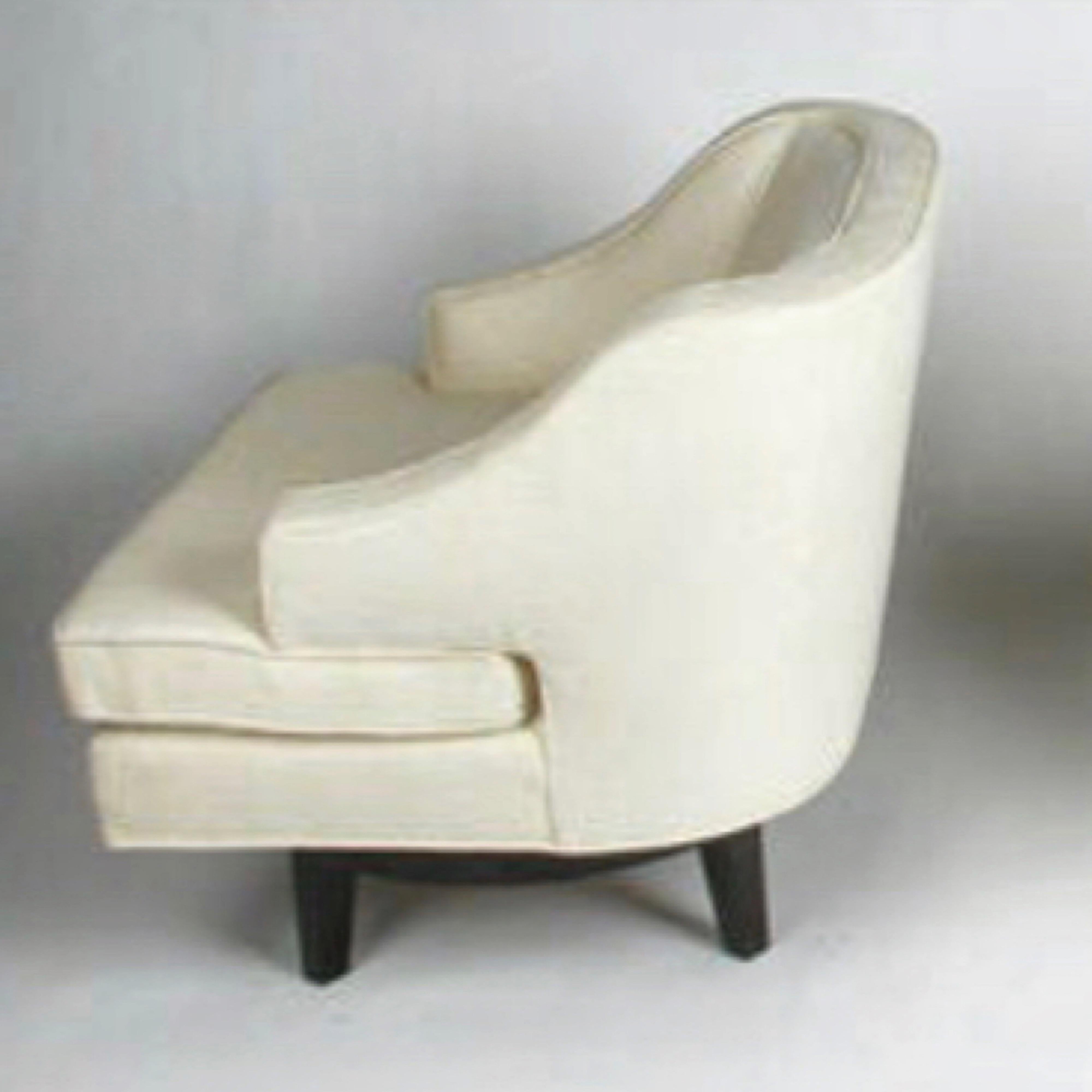 Pair of Tommi Parzinger swivel chairs for Charak Modern, circa 1940s. Model number M939. Rounded backs with jutting arms, mahogany swivel base. Available C.O.M. Shown in a white ivory fabric
Measures: H 28 in. x W 27.5 in. x D 29 in., seat height