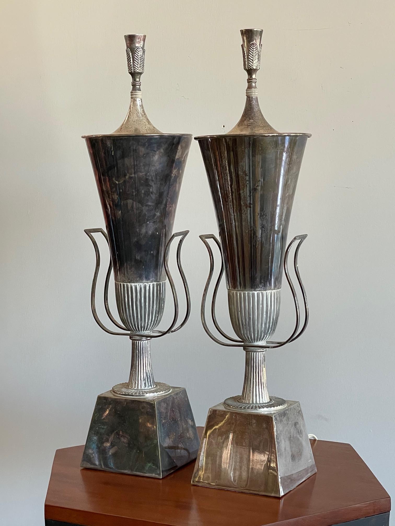 A pair of classic Hollywood Regency table lamps by Tommi Parzinger, Lightolier. Silverplate, complete with covers.