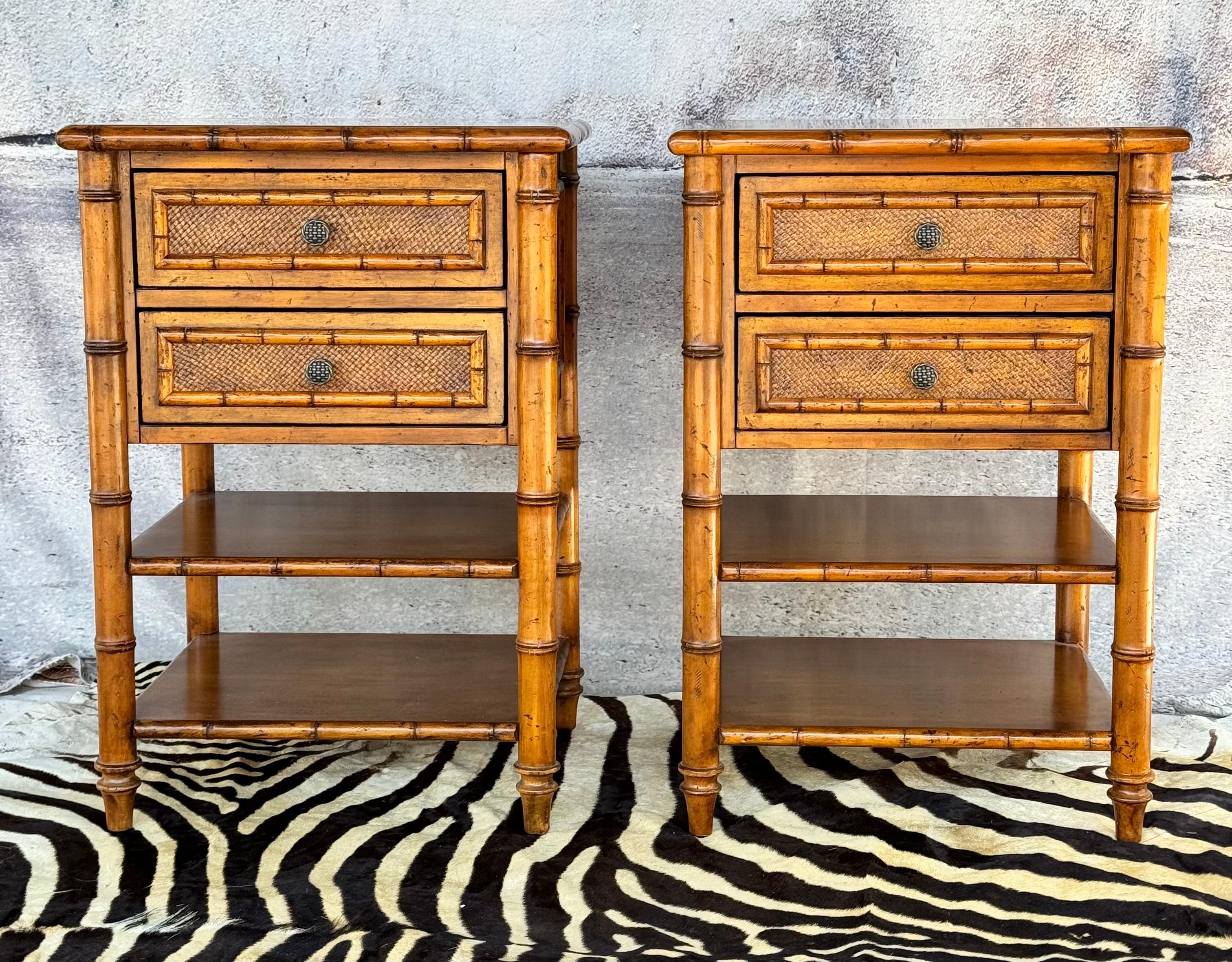 Pair of Tommy Bahama bamboo side tables/nightstands. Each features two drawers over two shelves.  Side tables / Night stands have an overall Bamboo motif. Metal Tommy Bahama tags reside in top drawers. 