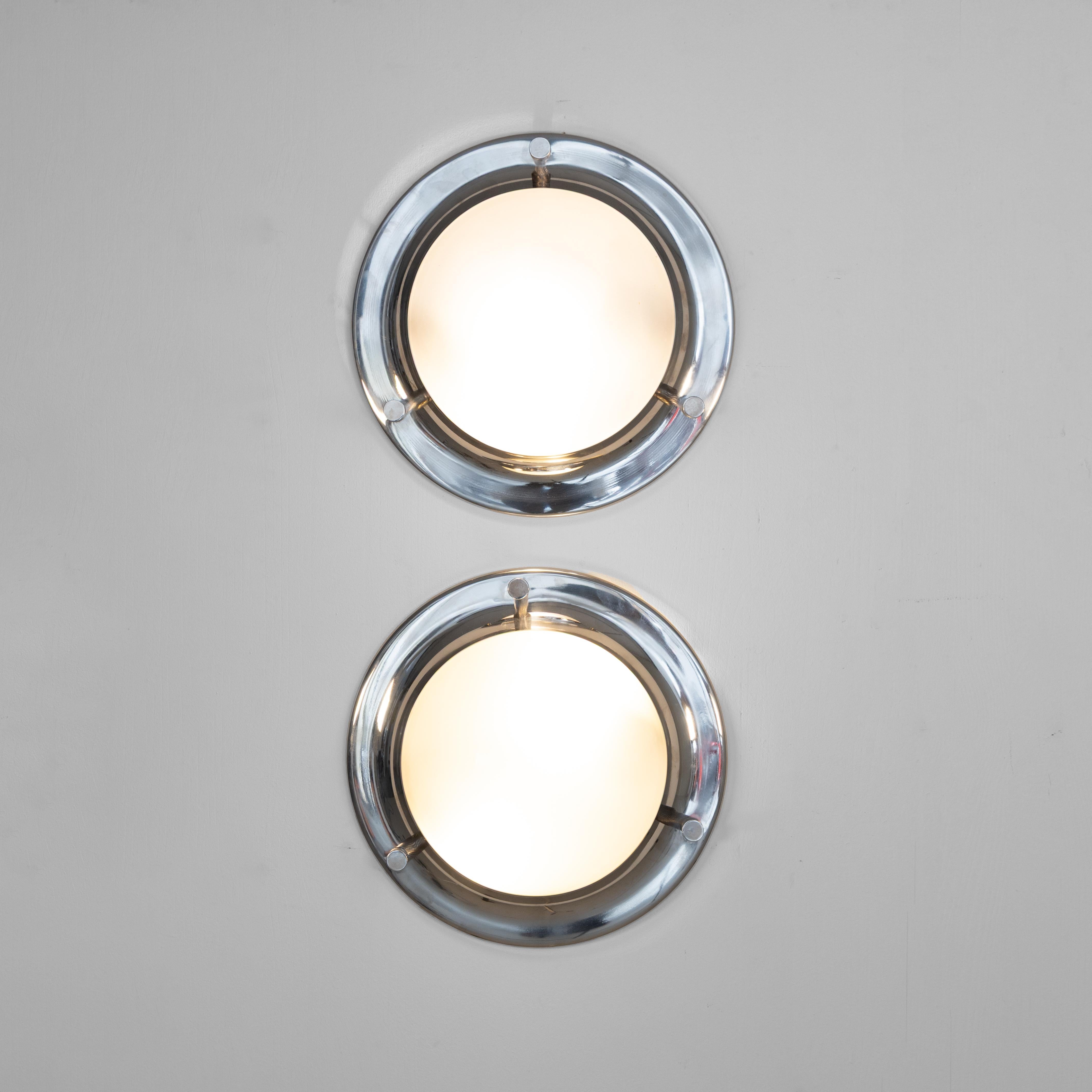 The Pair of Tommy LSP6 lamps, designed by Luigi Caccia Dominioni in Italy circa 1965, stands as a testament to timeless modern design. Crafted with meticulous attention to detail, these lamps showcase Caccia Dominioni's innovative vision and