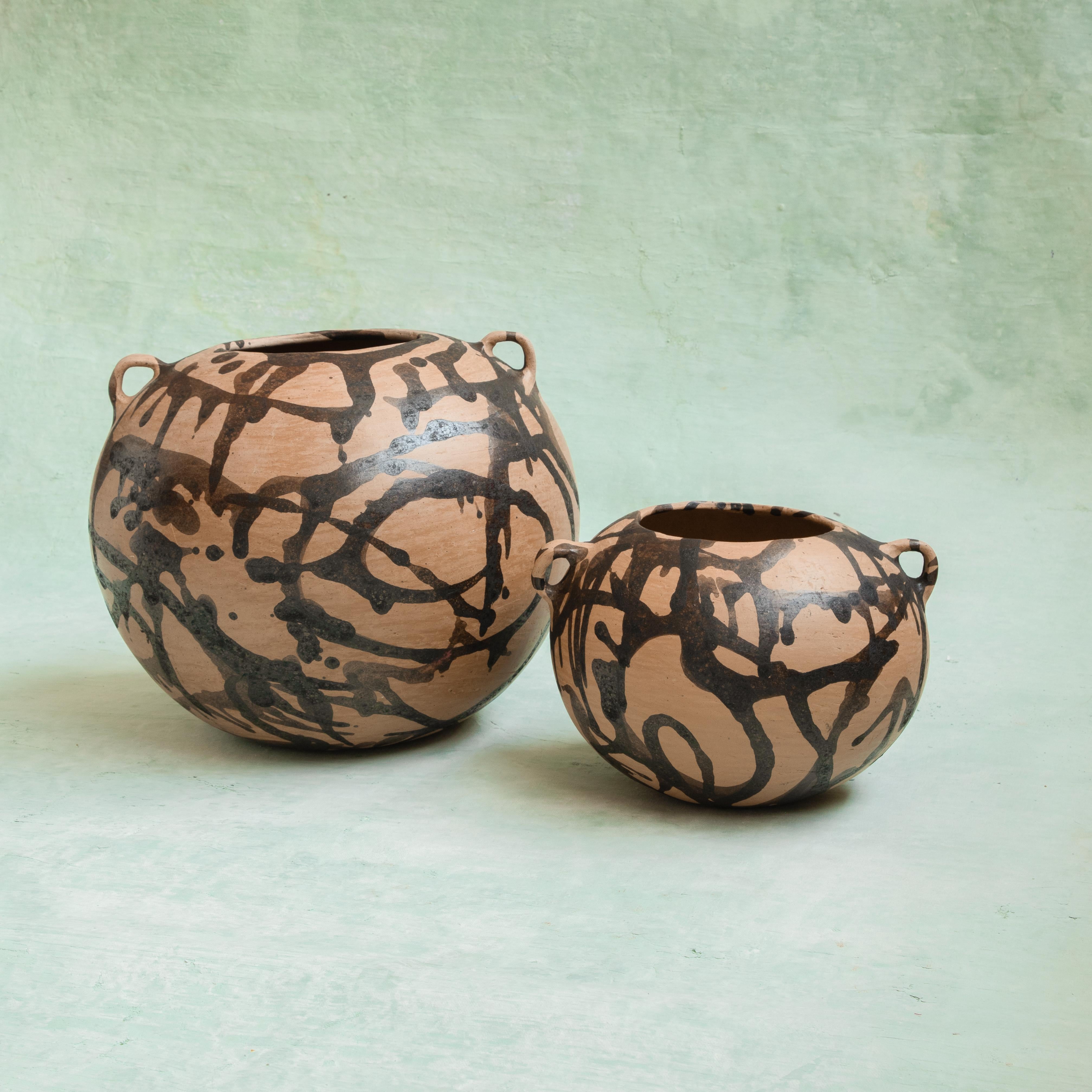 Pair of Tonaltepec Pots by Onora
Dimensions:
 D 30 x H 20 cm
 D 23 x H 18 cm
Materials: Terracotta

Terracotta pots hand modeled and painted using a splatter technique using oak bark dye, an endemic and ancient technique of Santo Domingo
