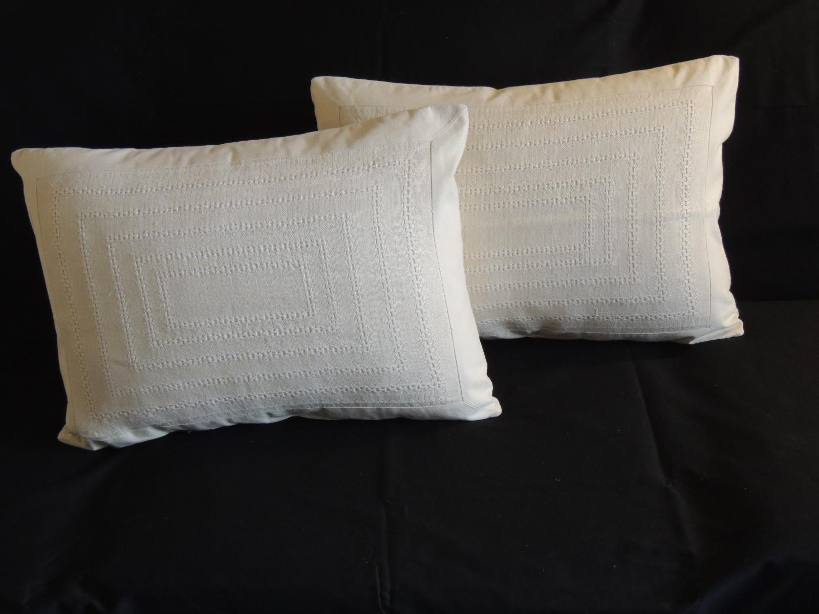 Pair of tone-on-tone beige eyelet linen decorative bolster pillows.
Eyelet woven linen pillows with linen frame and linen backings.
Decorative pillow handcrafted and designed in the USA. 
Closure by stitch (no zipper closure) with custom made