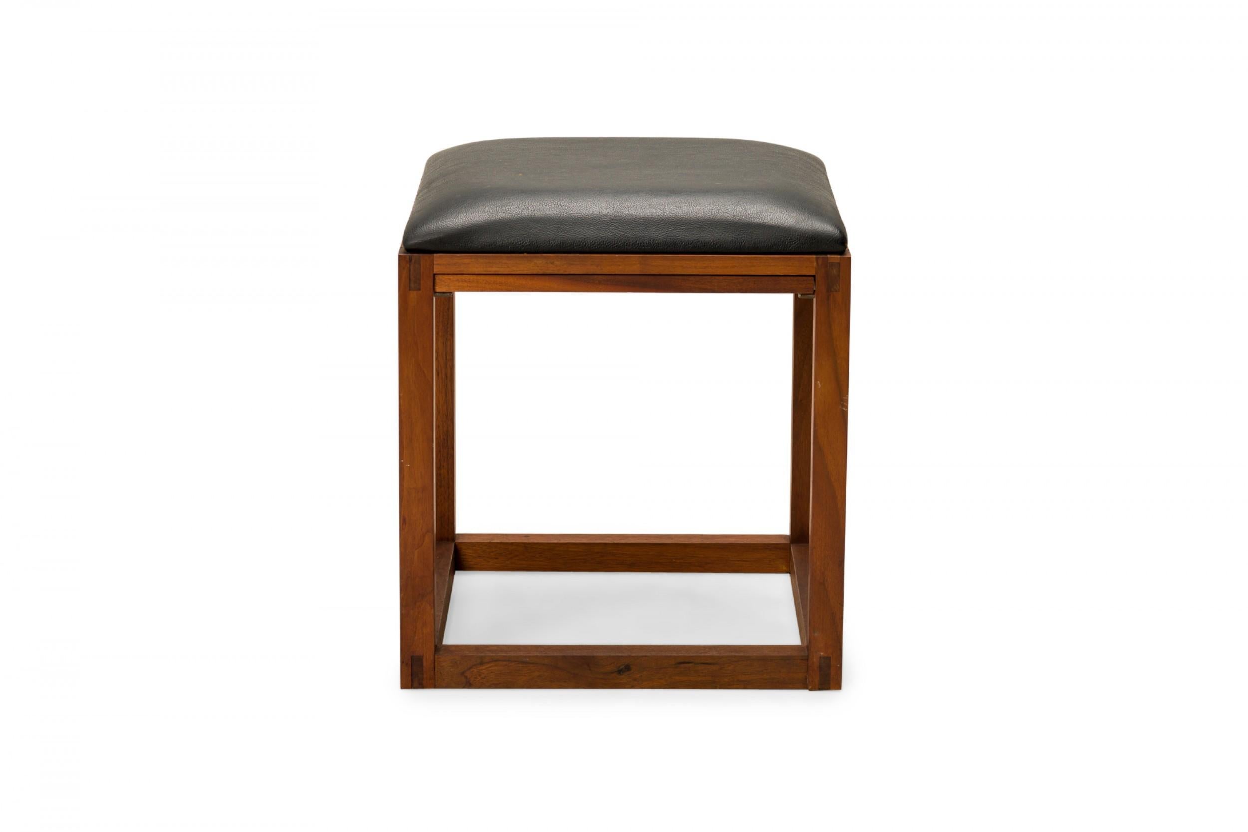 Pair of American mid-century stools with wooden cube frames concealing slide out trays beneath black leather upholstered seats. (TONY PAUL)(PRICED AS PAIR)(Available in gray: DUF0577)
 