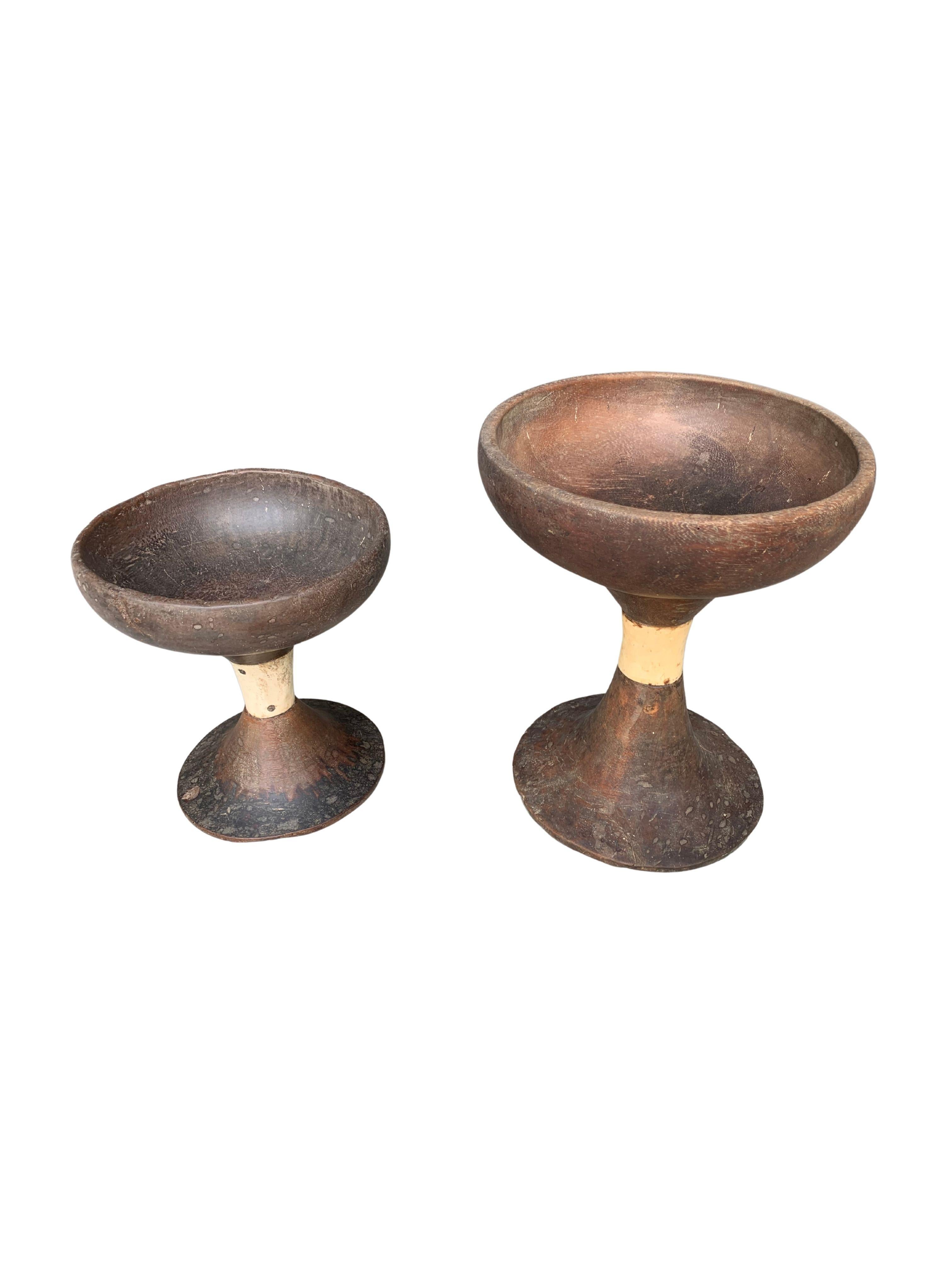 This set of wooden ceremonial bowls were crafted by the Toraja tribes people on the mountain highlands of Sulawesi, Indonesia. They are hand-crafted using 3 separate components (the base, middle and upper bowl) that are then joined together. It has