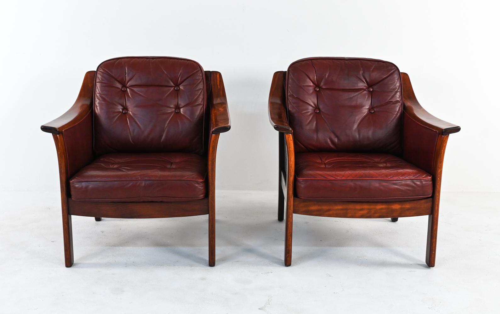 A rare and unusual pair of Norwegian mid-century lounge chairs designed by Torbjorn Afdal and manufactured by Bruksbo, Norway. Designed in the late 1960's and produced c. 1970's, these Scandinavian modern easy chairs feature subtly flared sides with