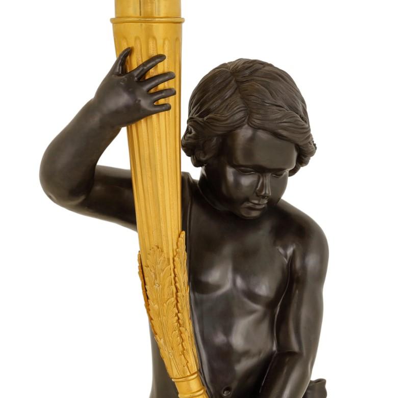 Beyond their function as light sources, this pair of torchères truly embodies the spirit of decorative art from the late 19th or early 20th century, where storytelling and allegorical representation were highly valued. The choice of a boy and a girl