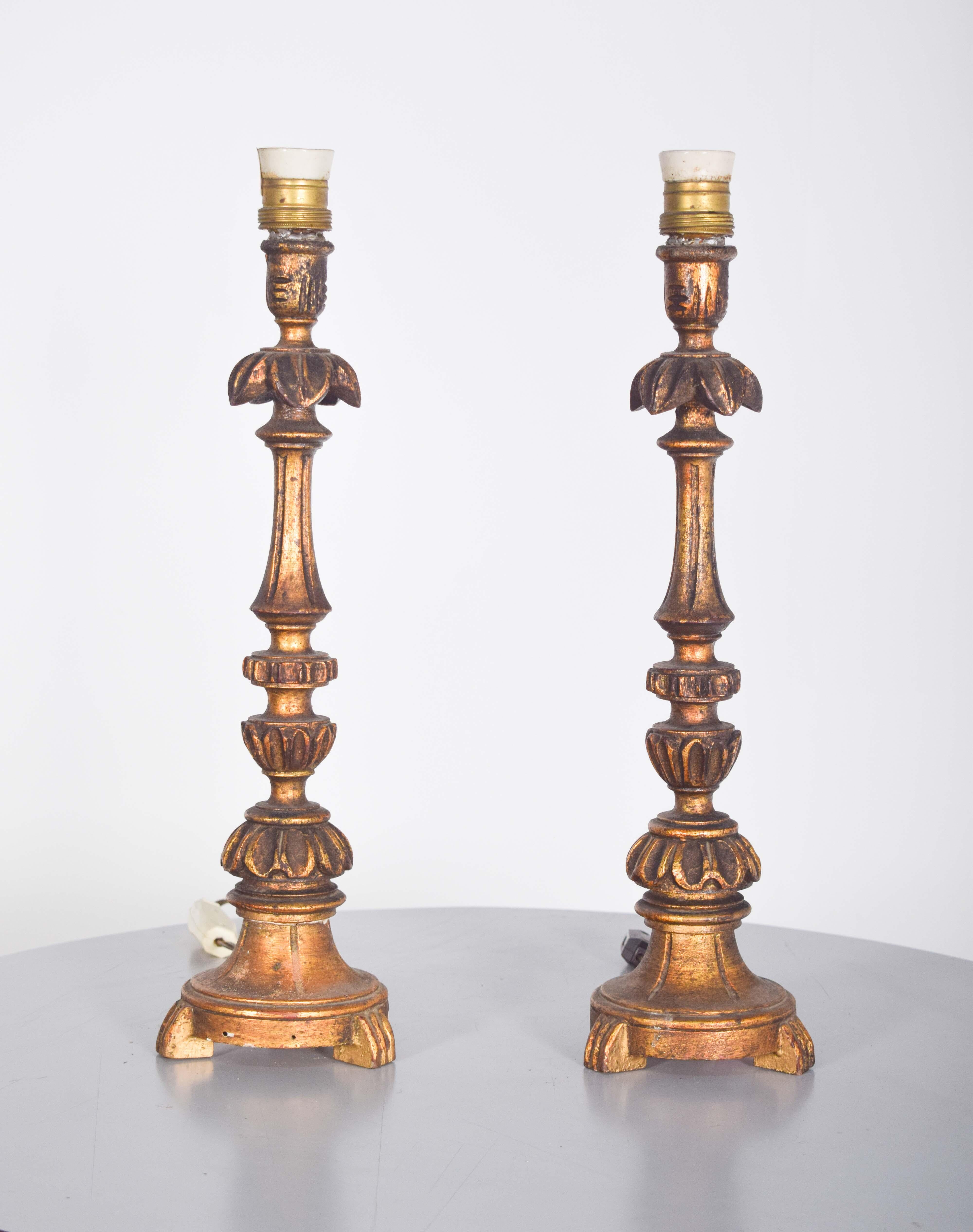 A stunning pair of Swedish silver candlesticks, each featuring a round rubber base for added stability. The candlesticks are elegantly decorated with intricate floral and leaf motifs, showcasing fine craftsmanship. Their timeless design and