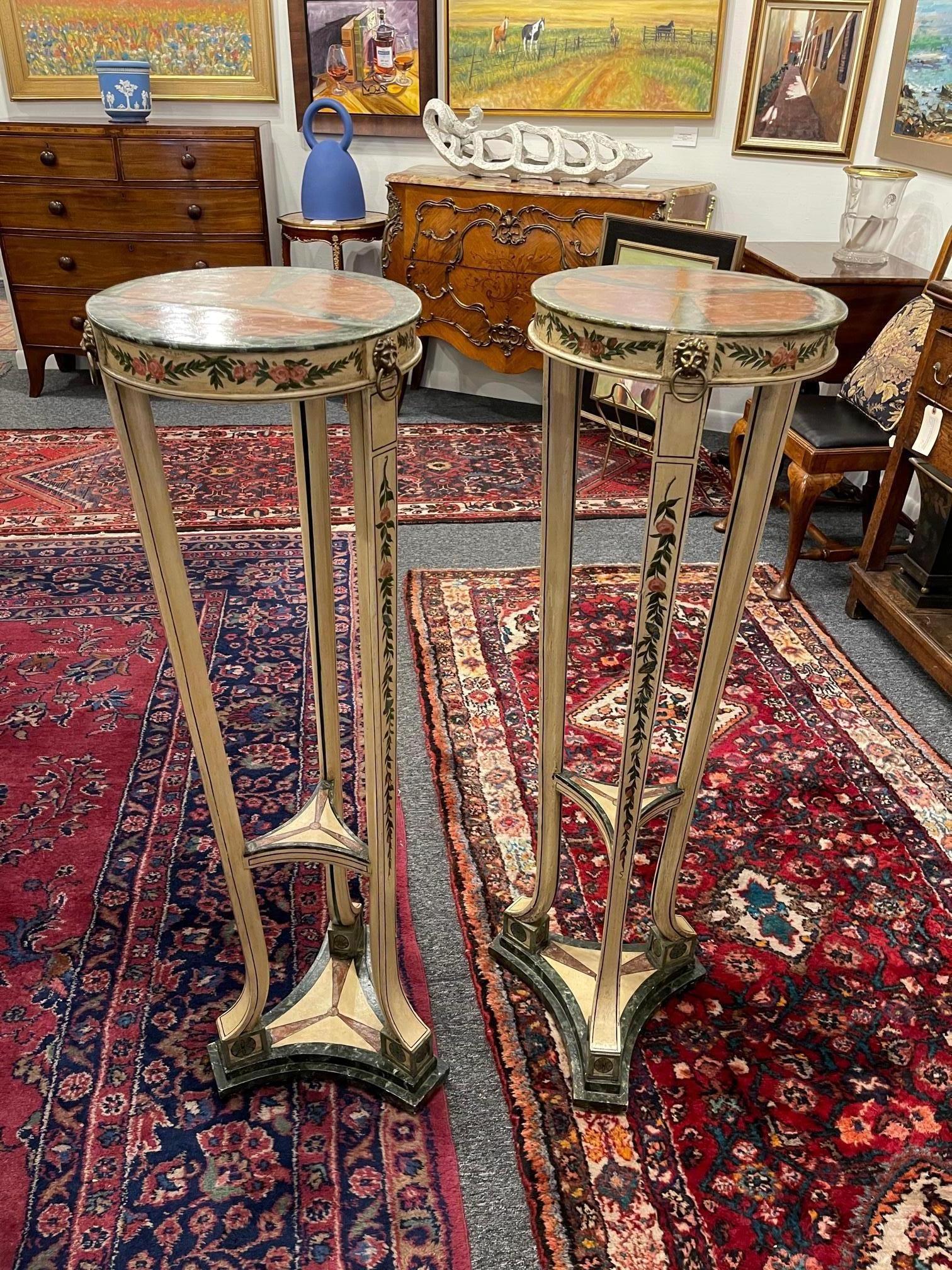Pair of torchère or pedestals painted, George III, circa 1800, each circular top painted to simulate marble panels, above a molded frieze, mounted with brass lion masks, raised on tripod support.
 