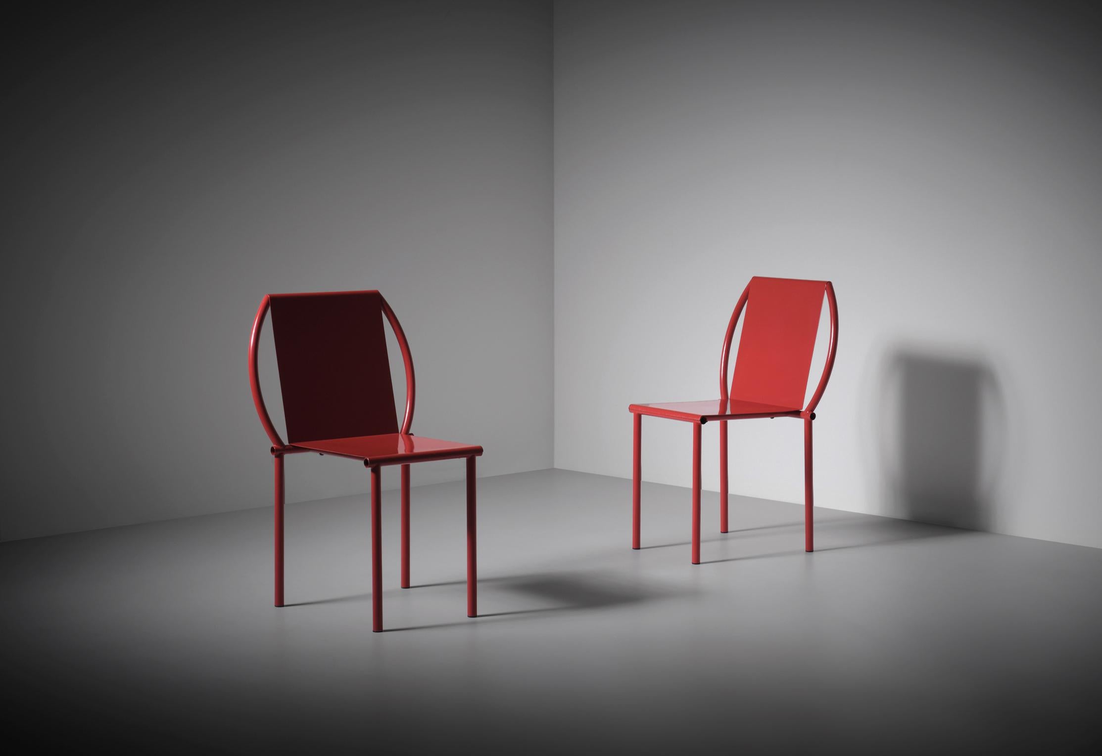 Pair of 'Toro' chairs by Martin Szekely, France 1987. The chairs were produced by Néotù gallery in a limited number of 200 examples. Minimal tubular and folded sheet steel frames finished with their original bright red lacquer. The combination of