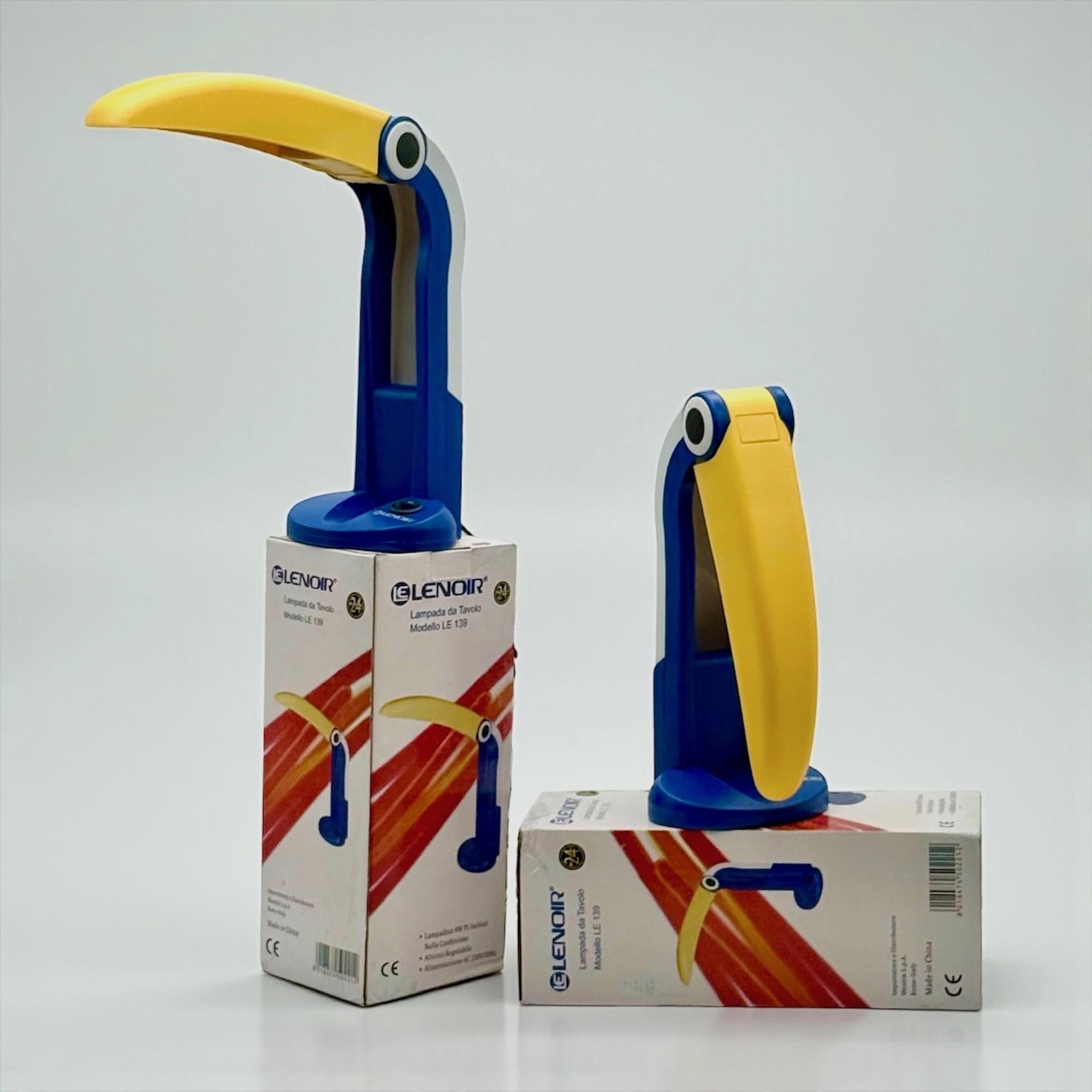 A pair of original Blue Toucan table lamps, model LE139, designed by HT Huang and distributed by Lenoir during the 1990s. Manufactured in China and imported to Italy, these lamps embody the cross-cultural creativity that defined late-century pop