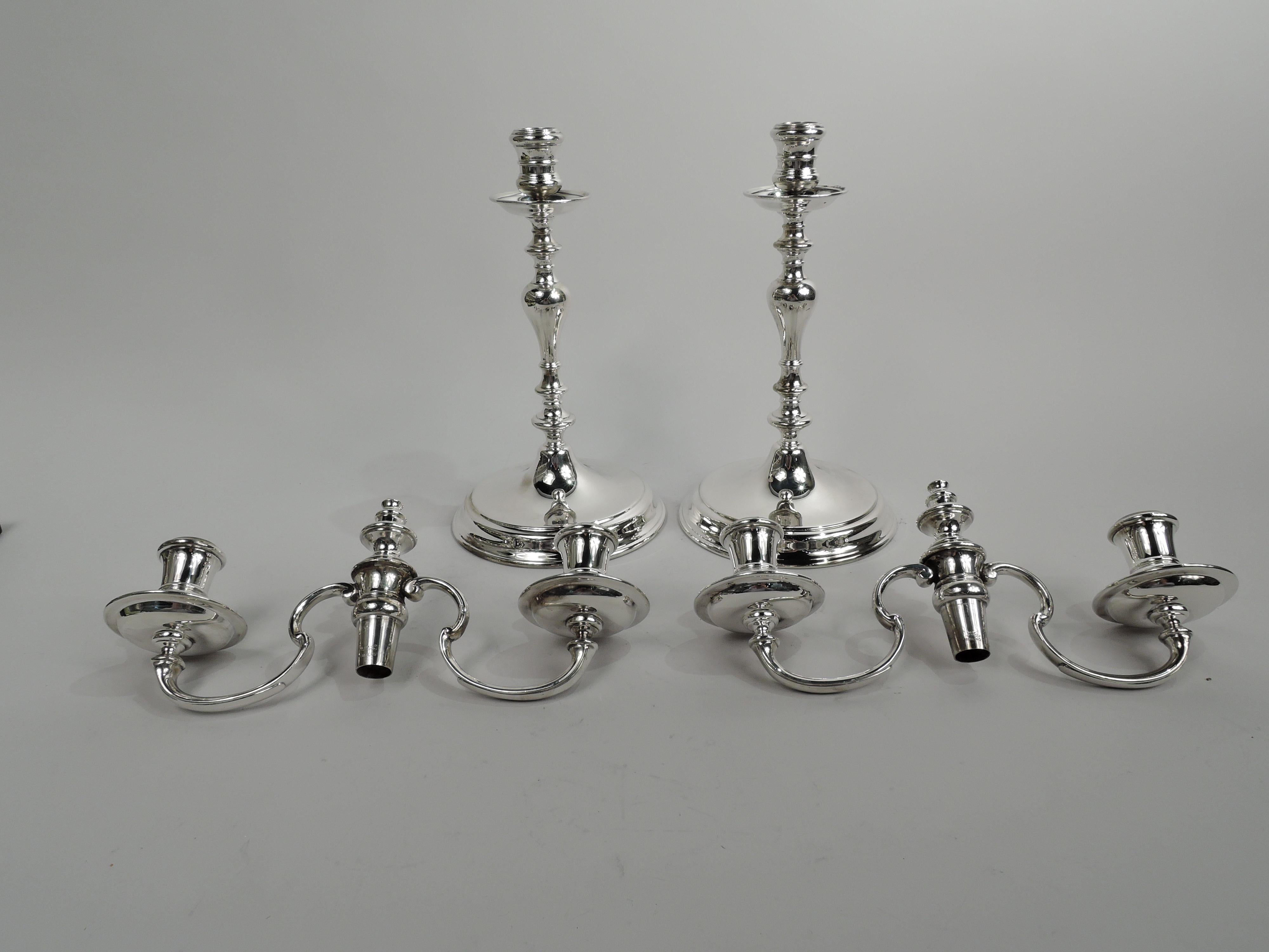 Pair of traditional American Colonial sterling silver 3-light candelabra. Each: Knopped baluster shaft on stepped and raised foot. Two scrolled arms each terminating in single socket mounted to wax pan. Central socket with detachable vasiform