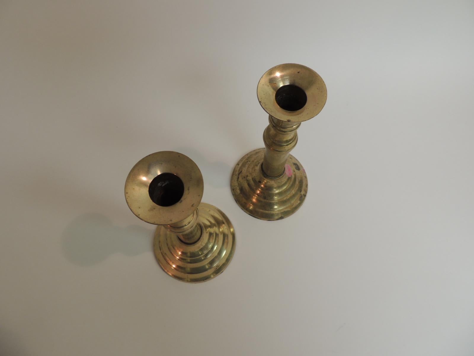 Pair of brass candle holders, round base with round pillar steams.
Polished brass. Felt covered bottoms.
Size: 4 D x 8 H,
1980s.