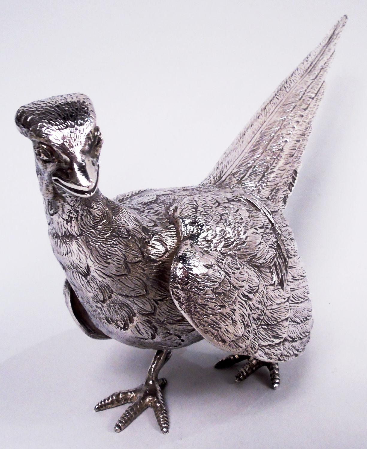 Pair of Elizabeth II sterling silver pheasants. Made by CJ Vander Ltd in London in 1966. The rooster is on alert, caught midstride with wings downed while the hen flaps wildly, neck outstretched. Well delineated plumage and scaly talons. Fully