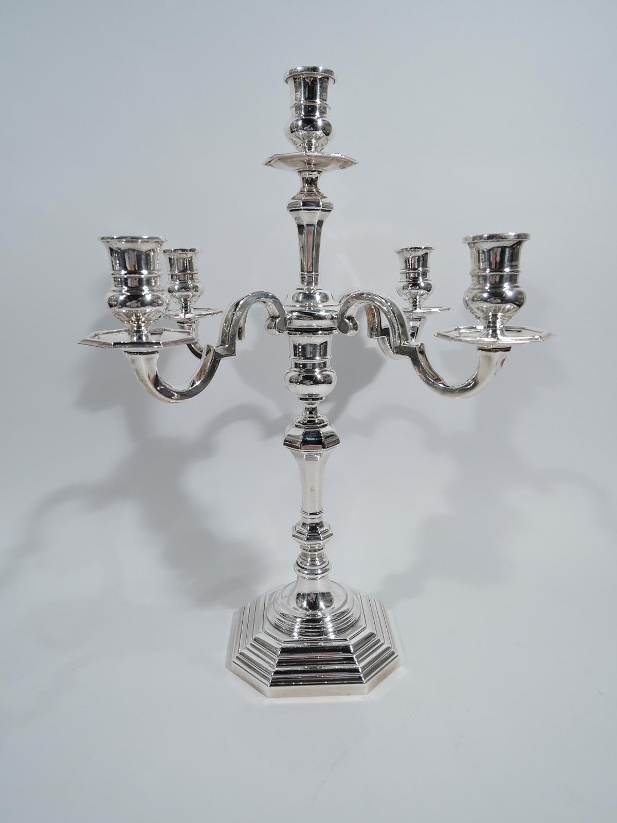 Pair of traditional sterling silver 5-light candelabra. Each: Faceted, knopped, and tapering shaft on round stepped foot mounted to stepped and chamfered square base. Four curvilinear arms, each terminating in single socket, and central raised