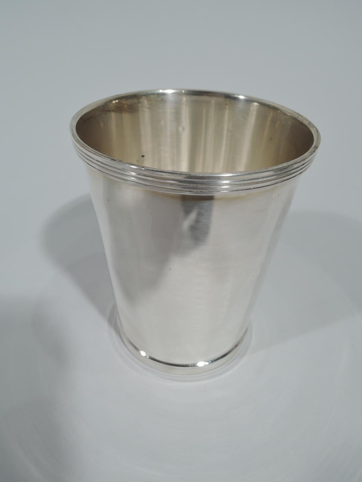 Pair of traditional sterling silver mint julep cups. Made by Fisher in Jersey City, New Jersey. Each: Straight and tapering sides, and reeded rim and foot. Fully marked and numbered 50. Total weight: 7 troy ounces.