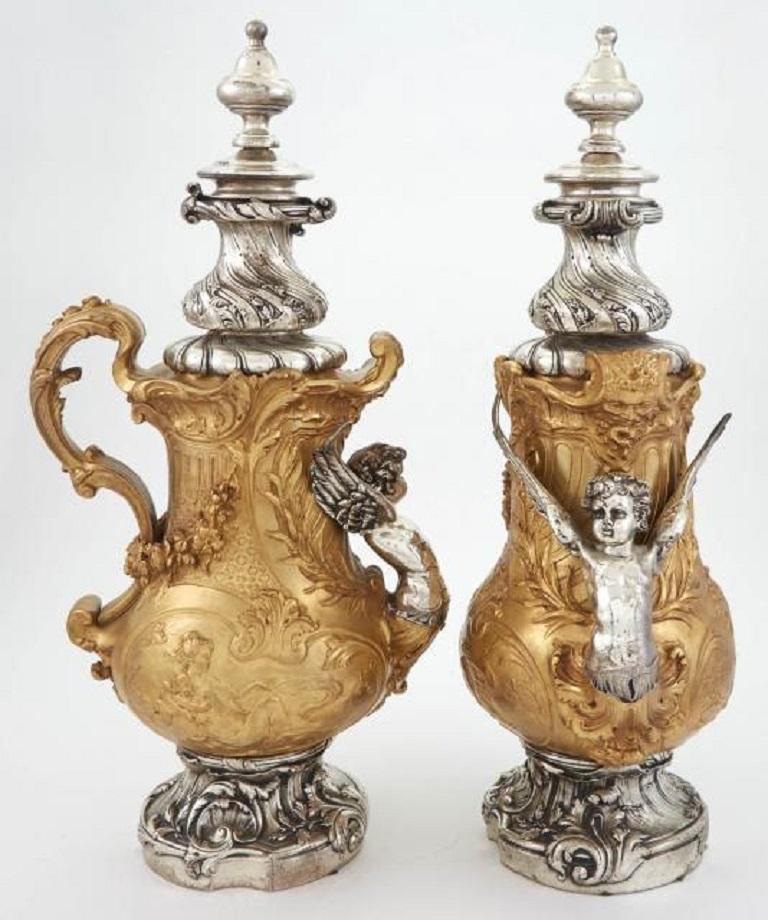 Pair of French 19 century Transitional Louis XV/XVI style silvered and gilt-bronze ewers
Measures: Height 20 1/4 inches.