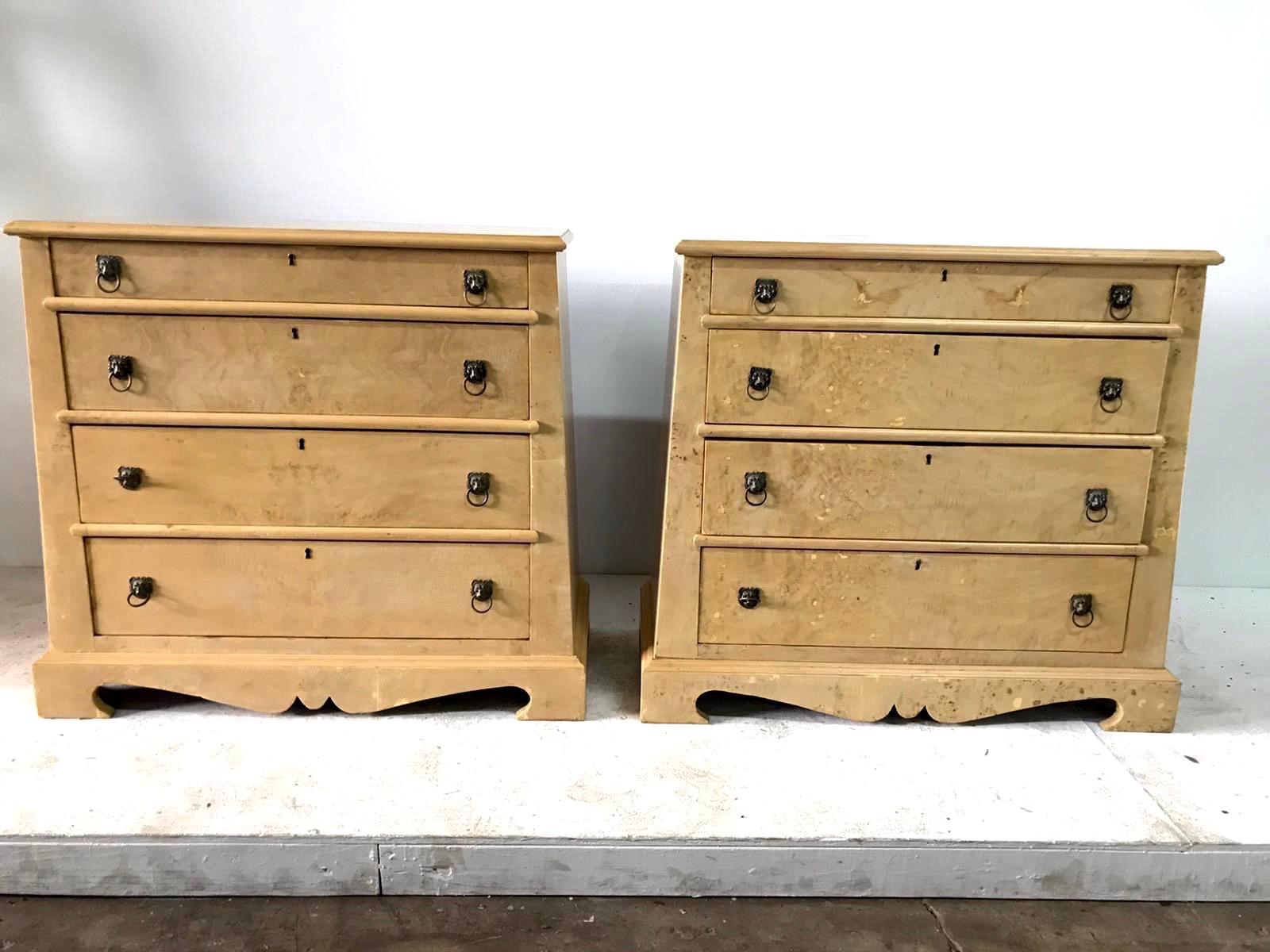 This important pair of trapezoid cabinets made of natural burled oak; comes from an L.A Hollywood estate. Branded with manufacturer's mark, Quigley. Likely a design by Samuel Marx. Four drawers each with lion head bronze pulls and key holes (missing