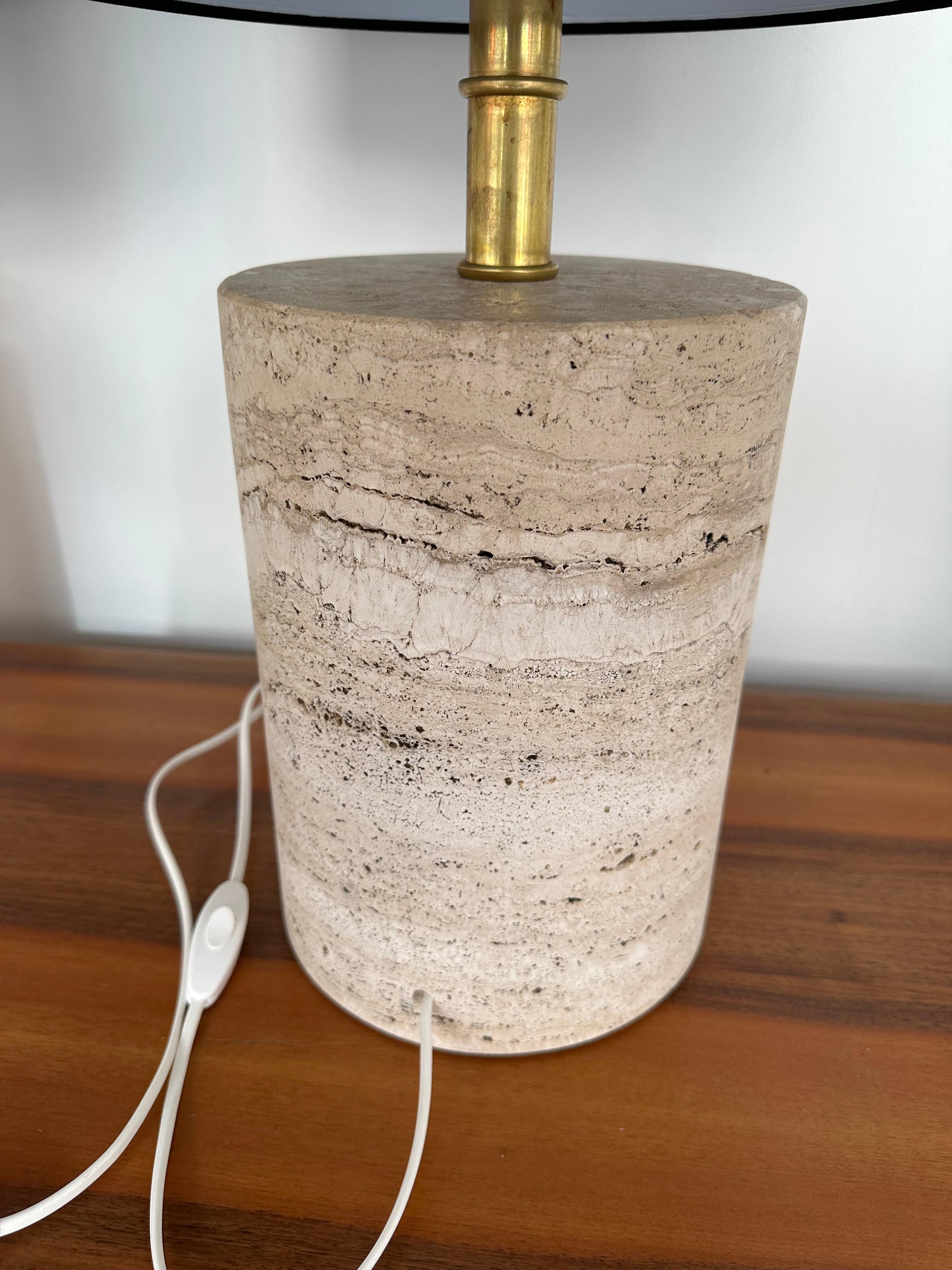 Mid-Century Modern Hollywood Regency style Tall pair of travertine stone a variant of marble and brass table or bedside lamps. Come with nice black shades. Measurements lamps only H45.5 x D20 centimeters

