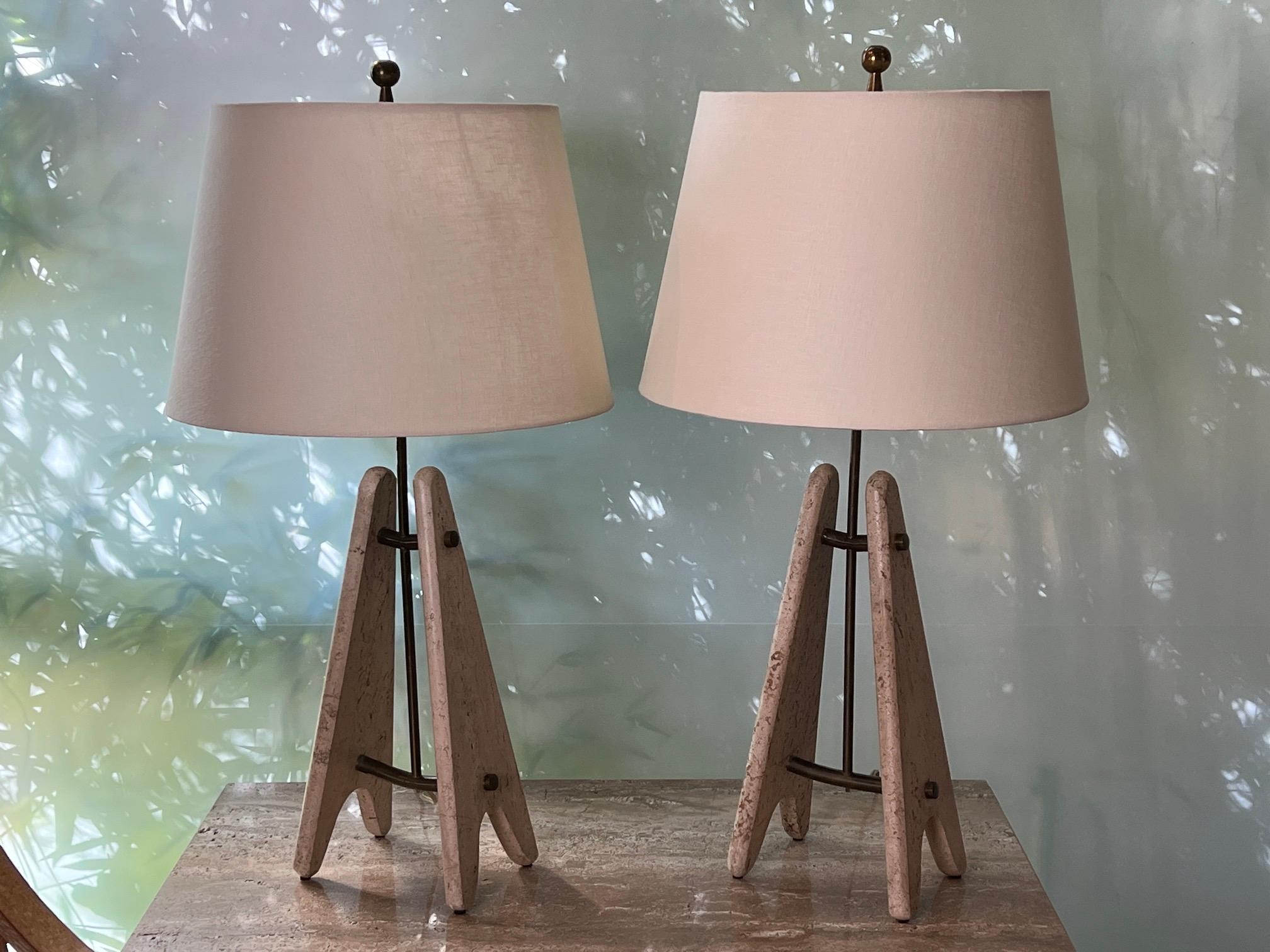 A sculptural pair of travertine and brass table lamps. 
Travertine measures 8