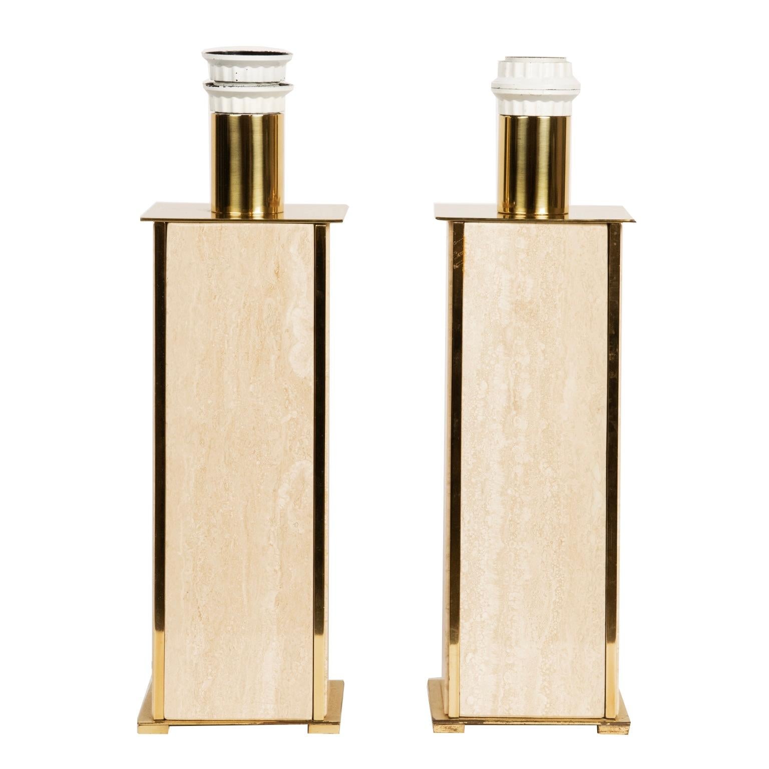 This important and handsome pair of weighty travertine and brass lamps come with off white linen rectangular shades (not pictured). The travertine stone is accented with a brass top, bottom and sides.
They are wired for North America.