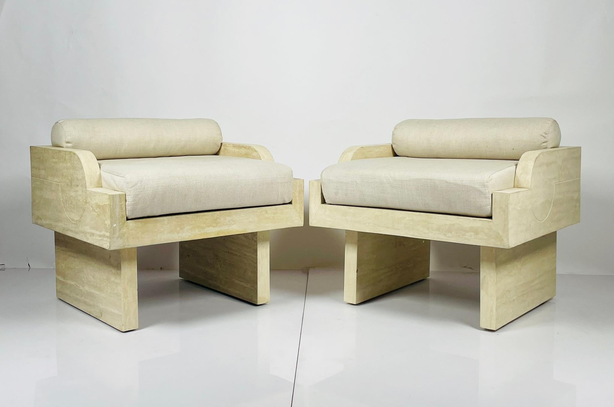 Stunning pair of armchairs designed and manufactured in France.
Made in solid travertine, beautiful architectural lines and upholstered in an off white fabric.

The chairs are attributed to Stéphane Parmentier's Gallipoli armchairs however these