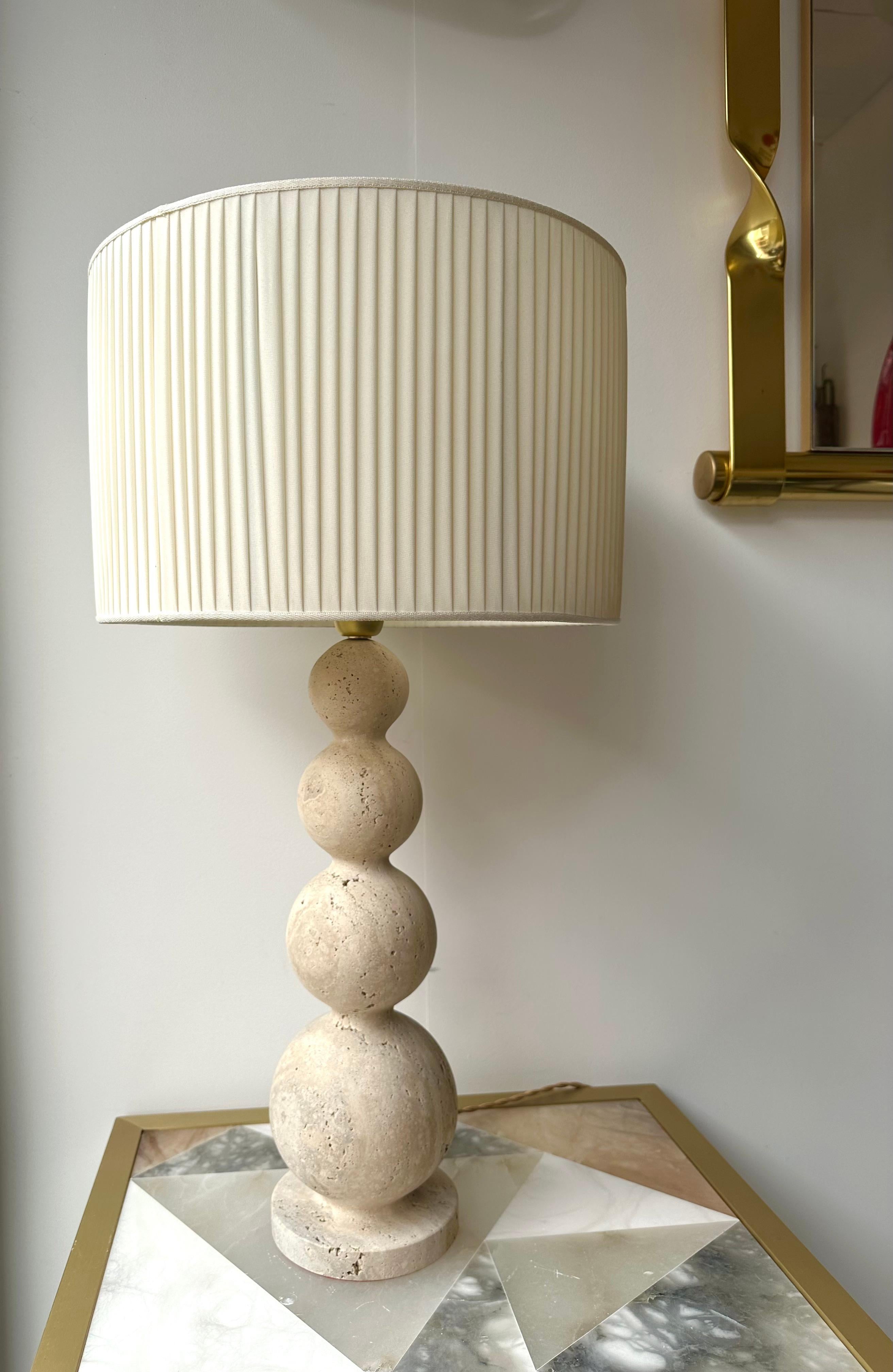 Mid-Century Modern Hollywood Regency style pair of Ball travertine stone a variant of marble table or bedside lamps. Cut in one piece block or travertine. Brass elements.

Measurements indicated with demo shades
Demo shades are not