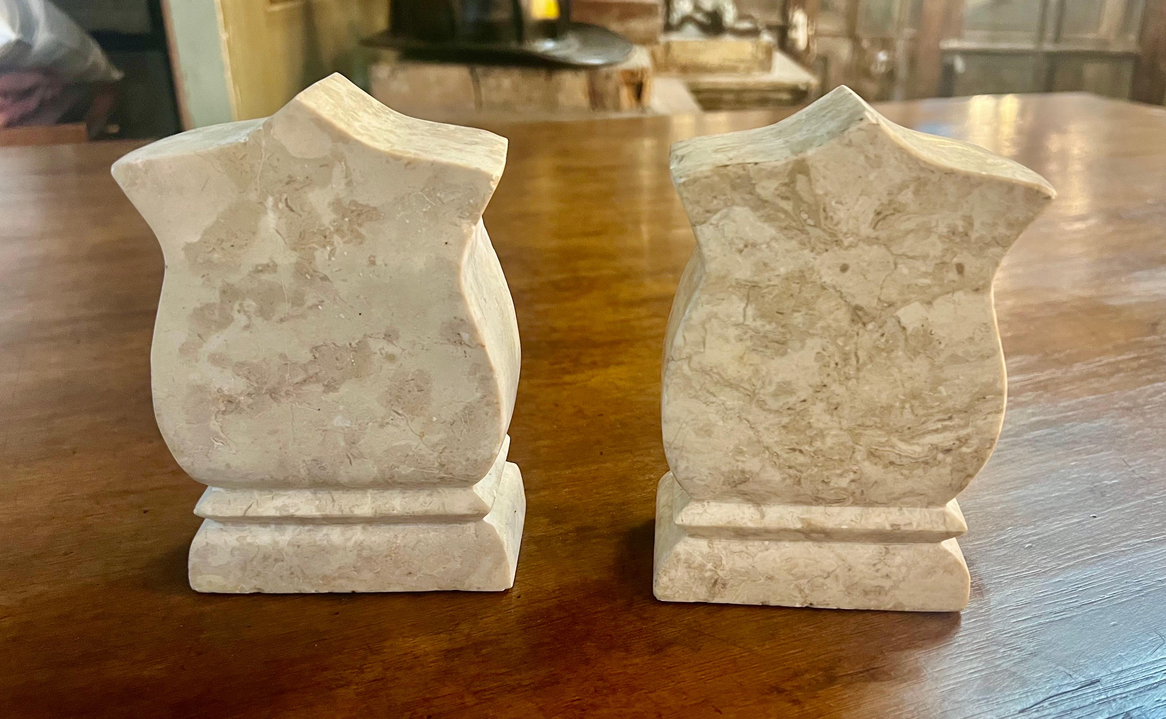 A pair of mid-20th century Italian travertine bookends carved in creams and beige coloration.  They are a classic and elegant addition to any bookshelf of decor.