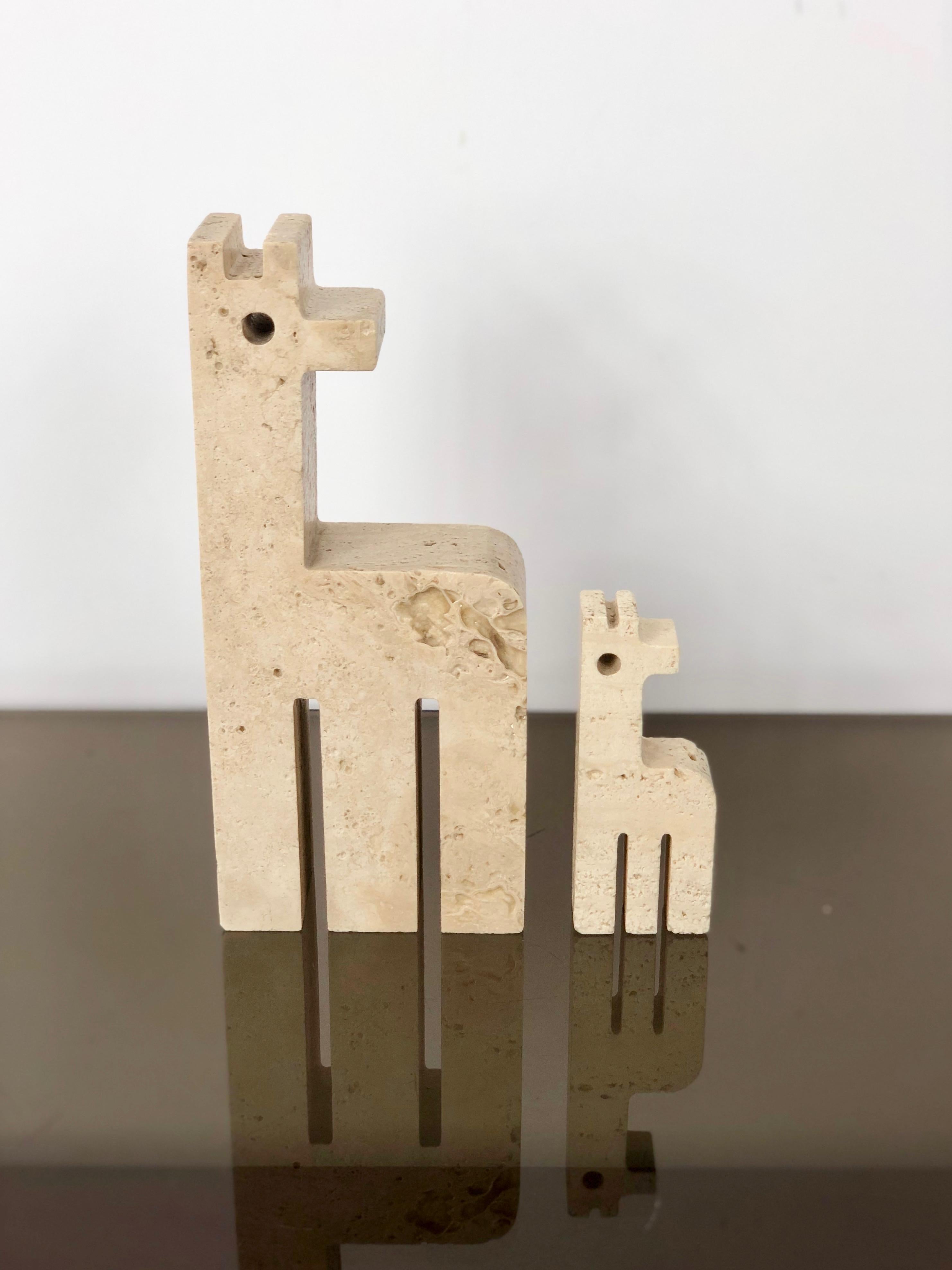 Pair of paperweight / sculpture in travertine, mum giraffe and her cub, by the Italian marble designers Fratelli Mannelli - Italy, 1970s. 

Dimensions:
Big giraffe: 20 x 9 x 4 cm (H x W x D);
Little giraffe: 10 x 4 x 2 cm (H x W x D).