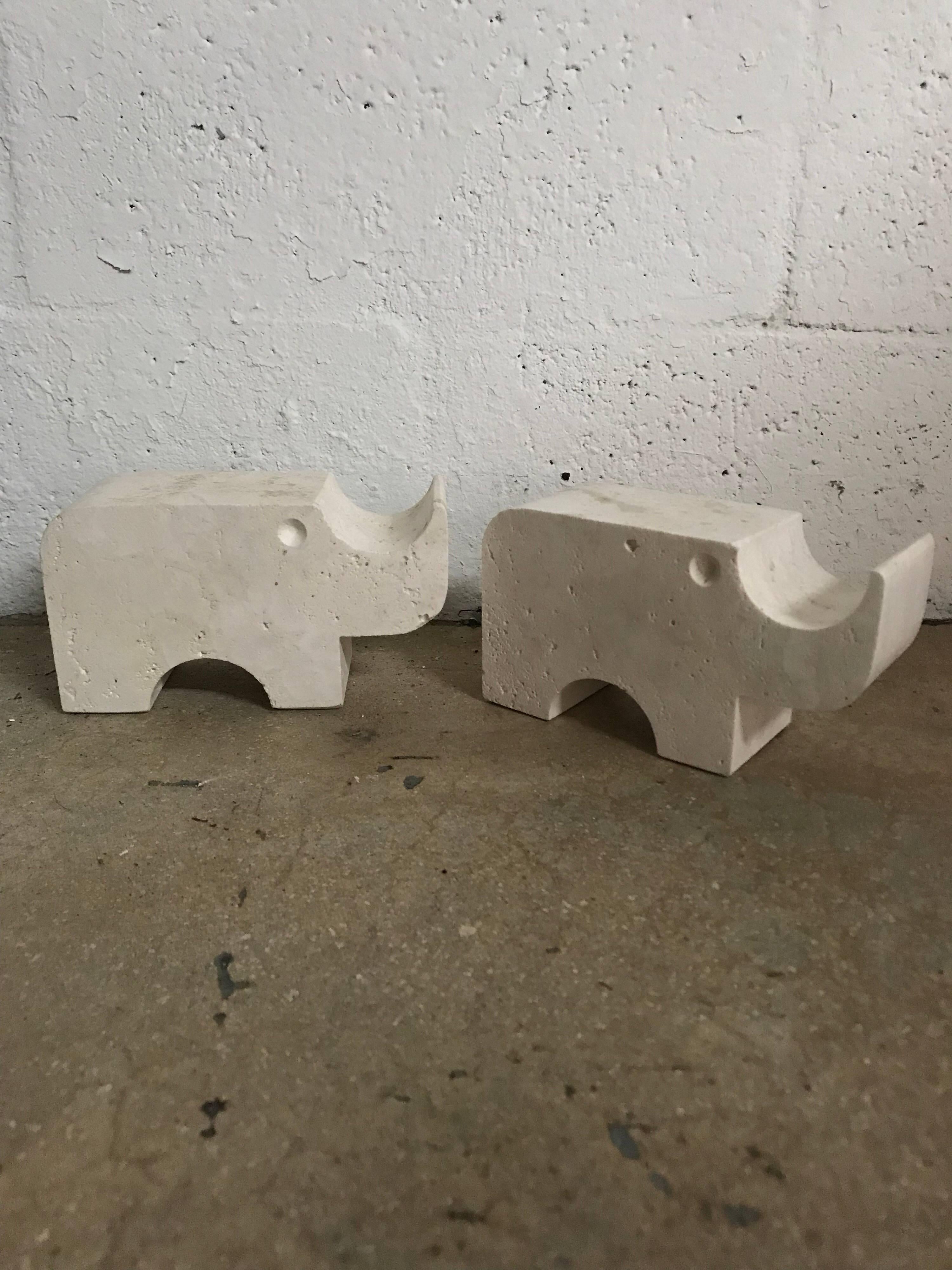 Solid pair of Rhino sculpture statues or bookends rendered in carved travertine, designed by Flli Mannelli for Raymor, Italy, 1960s, Signed.
